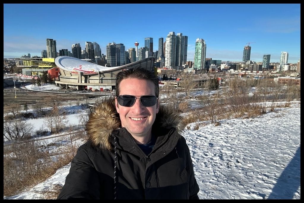 An image showing Ryan Gillard the Realtor on Scottman's Hill overlooking Calgary's downtown in the winter time.