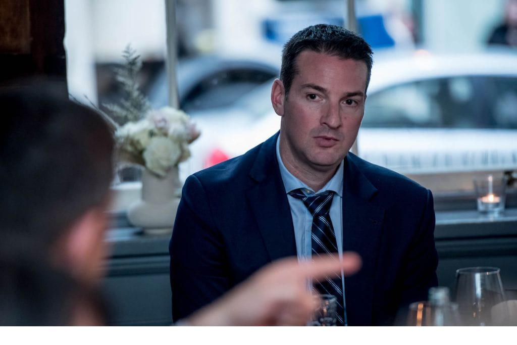A picture of Ryan Gillard the realtor in Calgary meeting with sellers.
