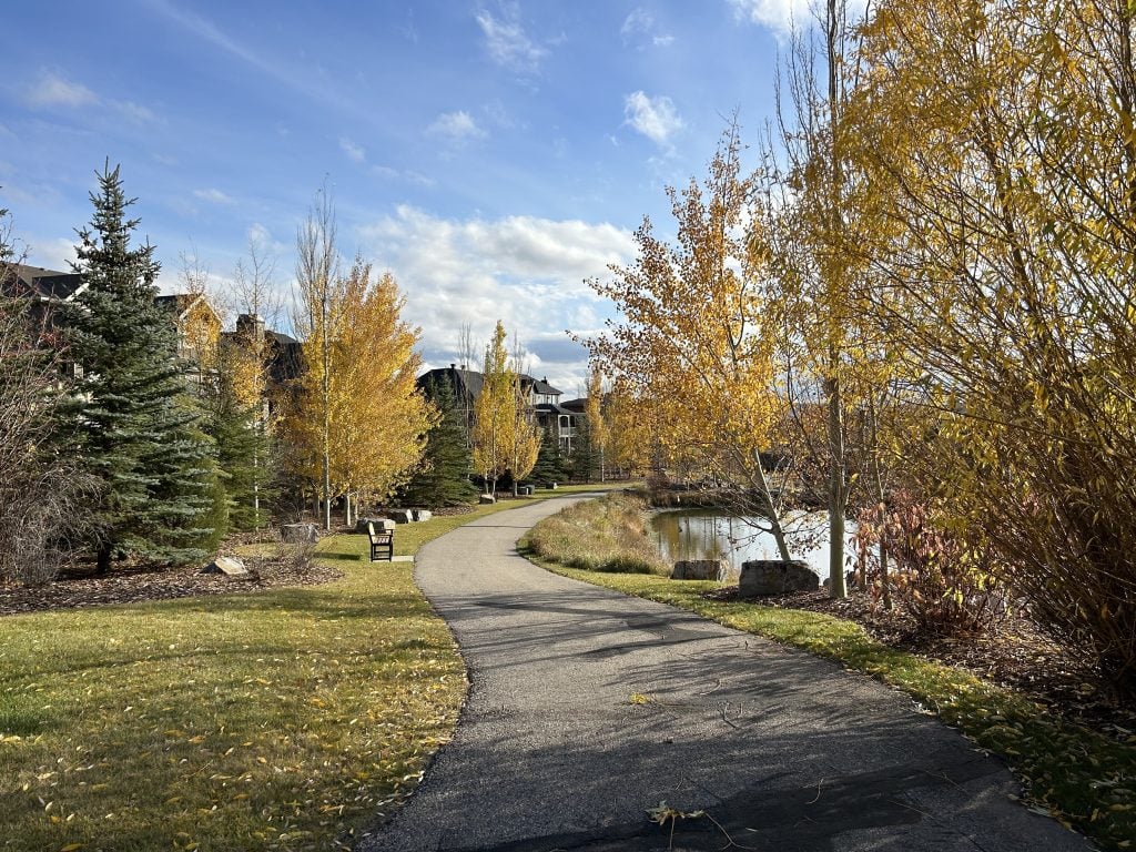 A walking path and pond in family friendly Watermark, Calgary.