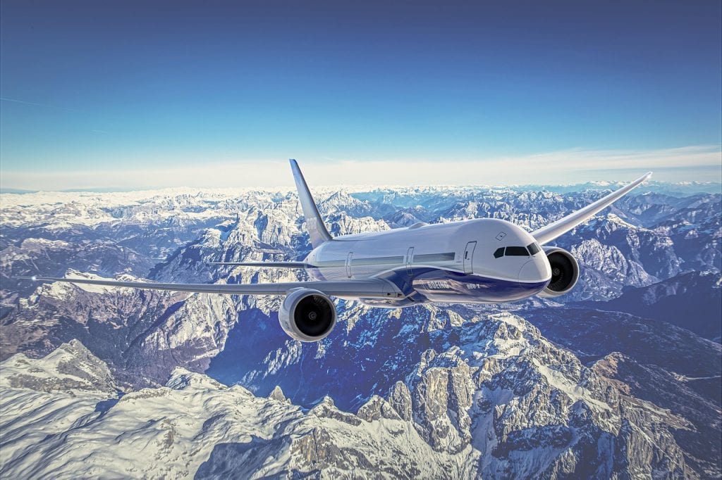 An airplane flying over the mountains.