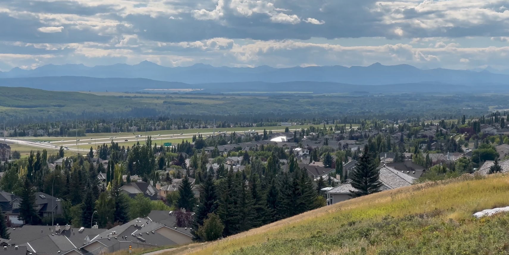 An image of a freeway in Calgary with the Rocky Mountains in the distance.