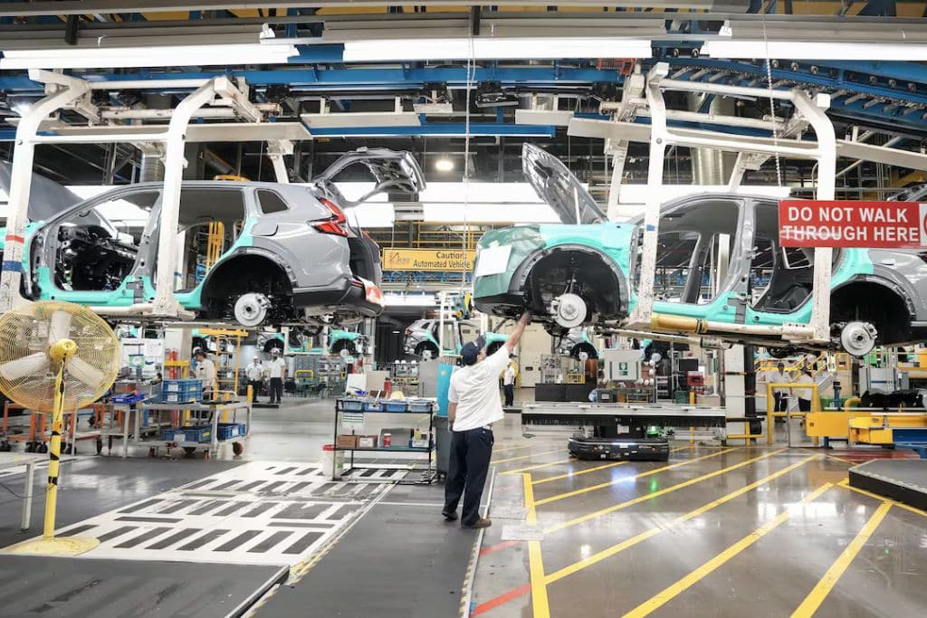 An image of an automative worker building a car in factory in Ontario.