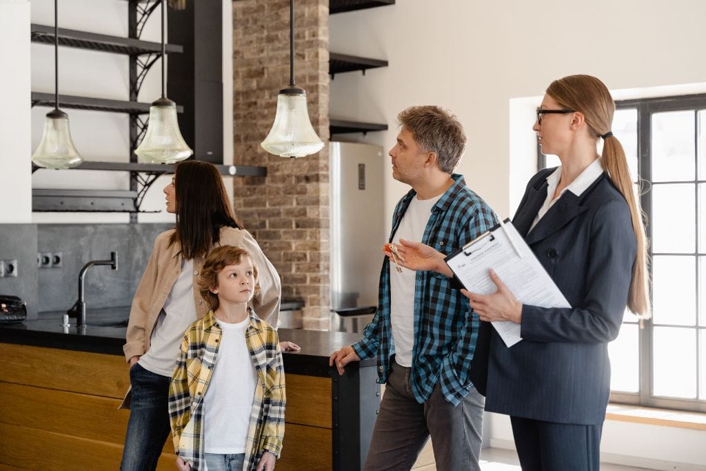Real estate agent showing buyers though a home.