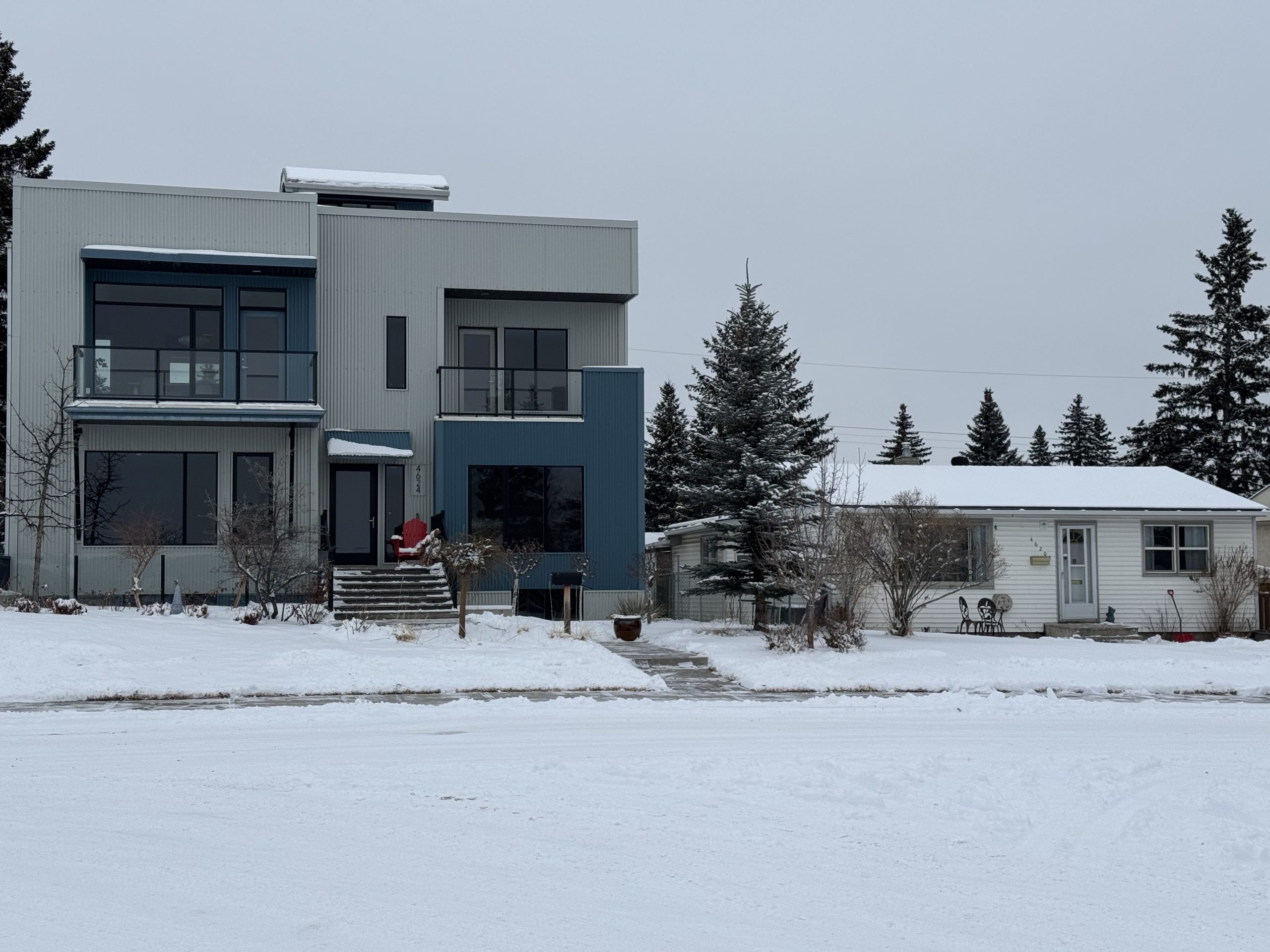 Modern infill home next to older bungalow in Montgomery Calgary, showing contrast in redevelopment styles.