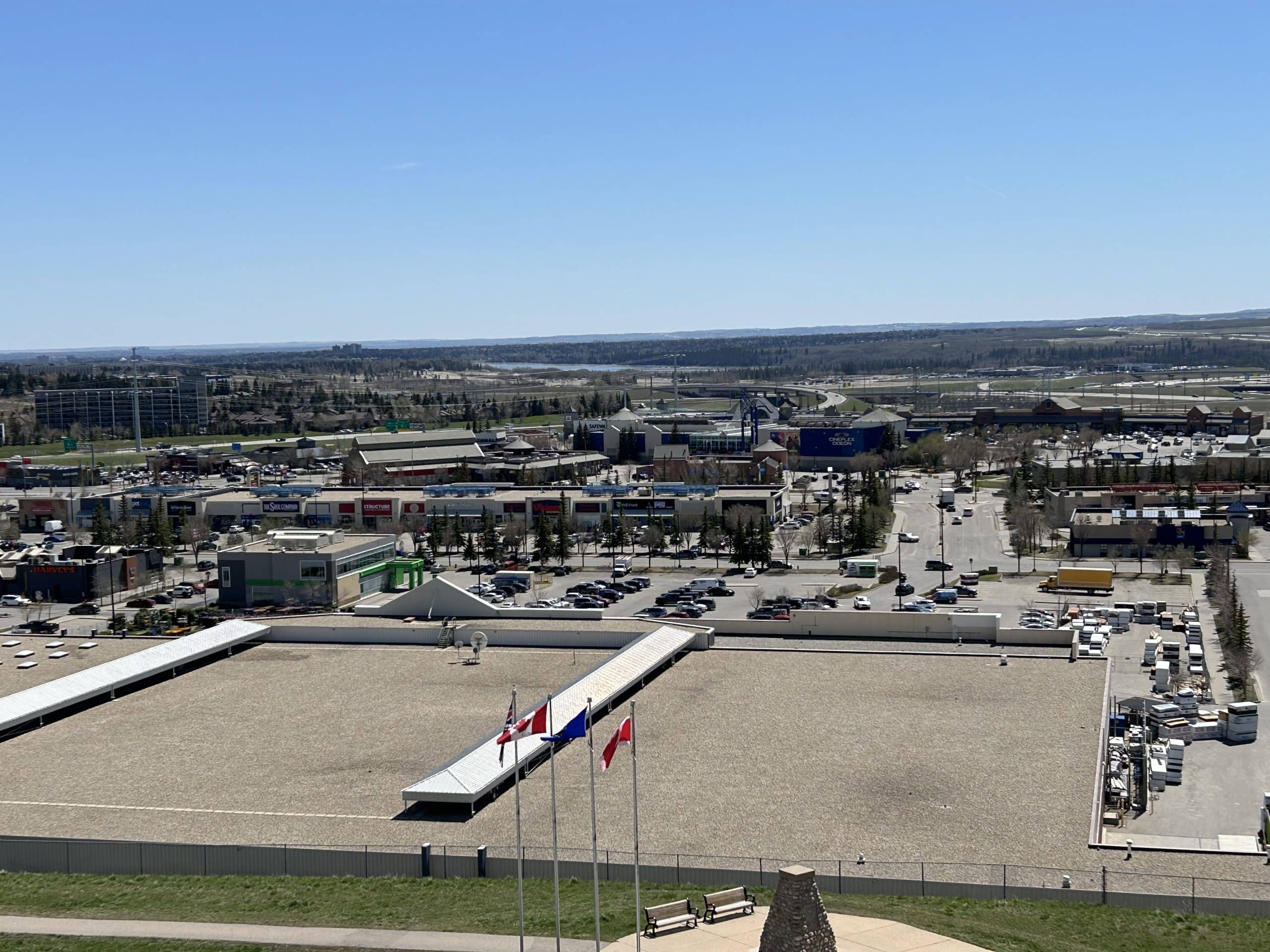 Aerial view of West Hills and Signal Hill retail area near Springbank Hill Calgary, featuring shopping plazas, parking lots, and major road access.