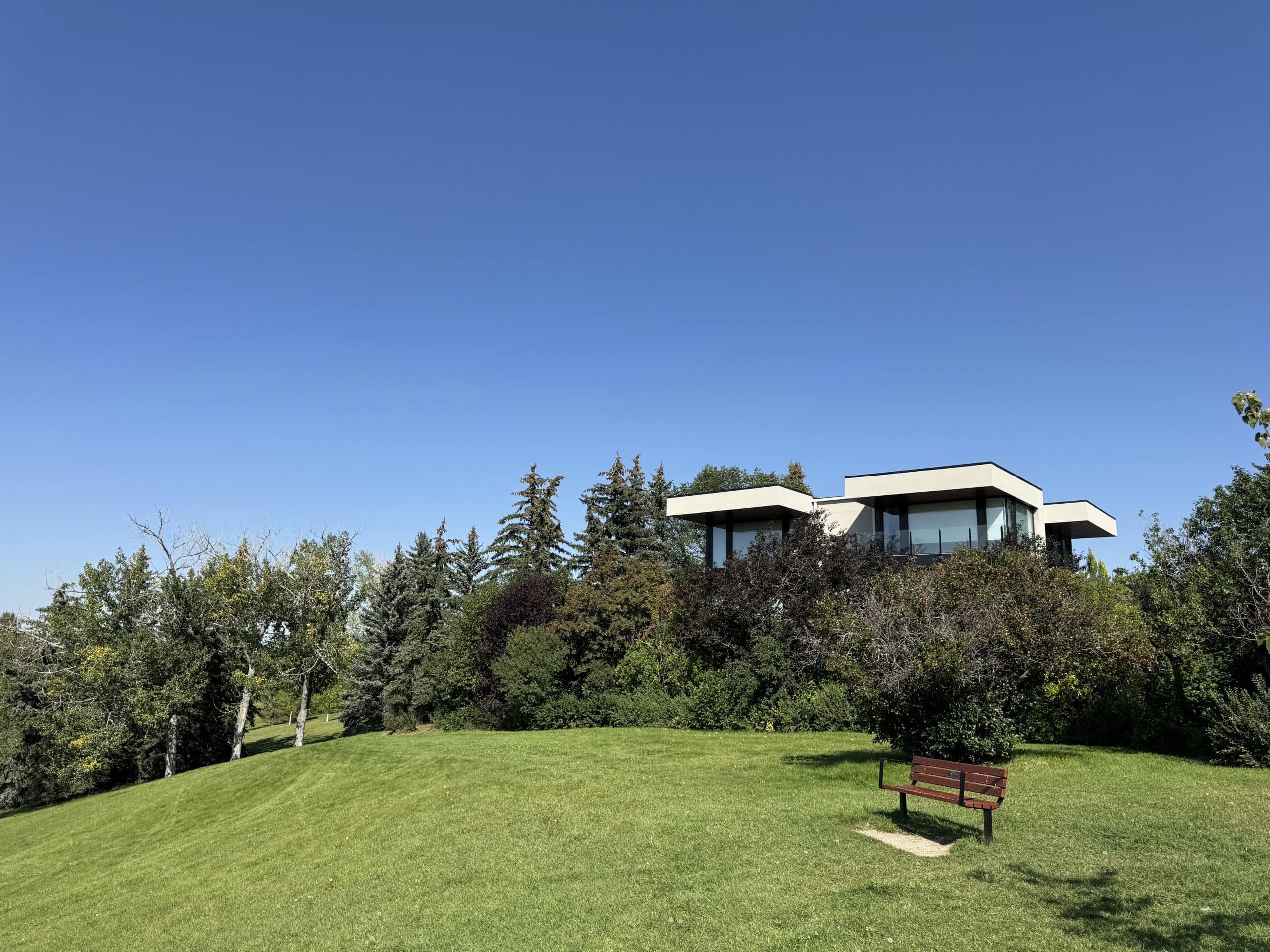 Modern luxury home in Mount Pleasant, Calgary overlooking Confederation Park, surrounded by trees and open green space in a sought-after inner-city community.