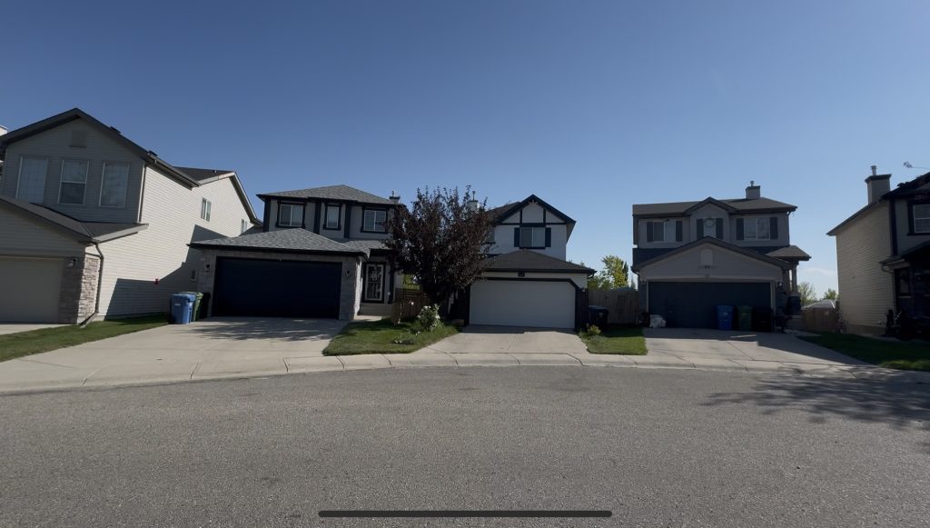 Detached family homes in Coventry Hills, Calgary with front garages and quiet suburban streets, highlighting affordable real estate in the city’s northeast.