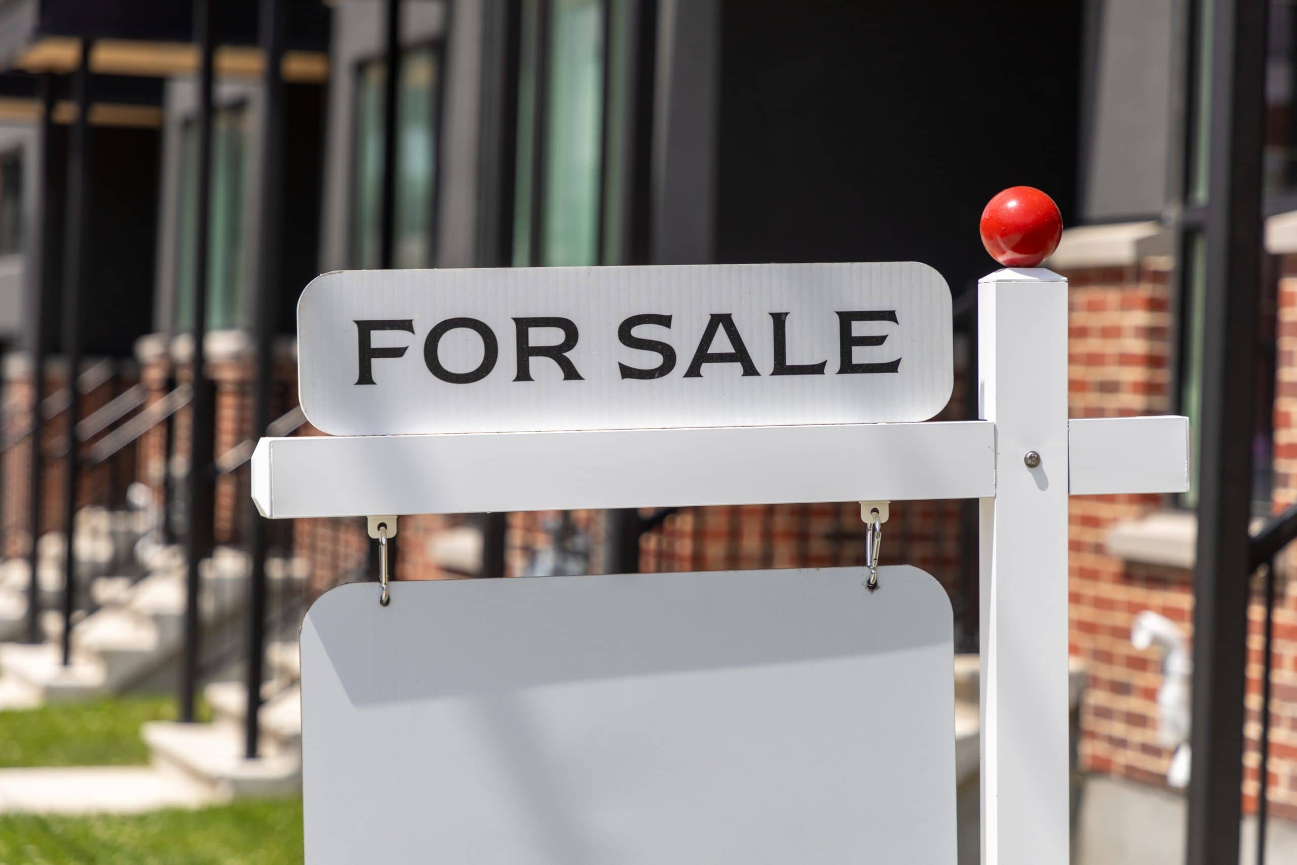 For sale sign in front of a residential condominium building. Real estate