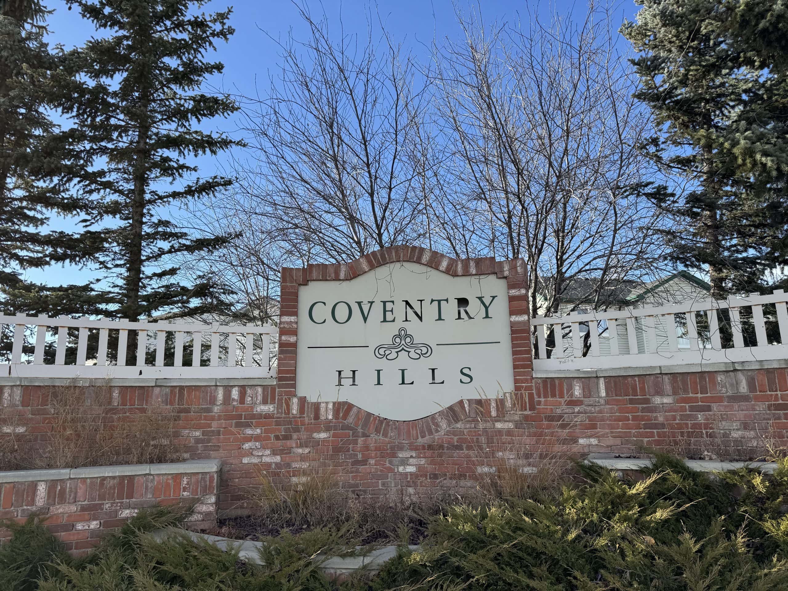 Entrance sign for Coventry Hills in northeast Calgary, welcoming residents to this affordable and family-friendly community known for parks, schools, and quiet suburban living.
