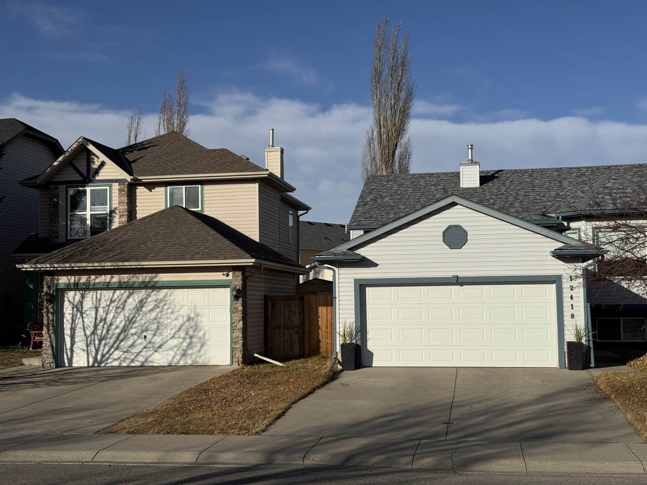 Detached single family homes with front garages in Coventry Hills Calgary, representing the affordable suburban housing style popular with families in the area.