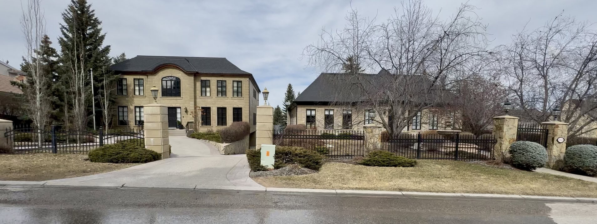 Luxury estate homes in Pump Hill with grand stone pillars, gated entries, mature trees, and spacious landscaped lots on a quiet upscale street in South Calgary.
