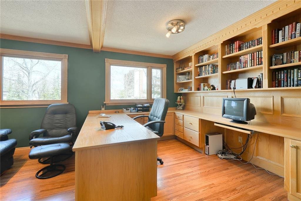 Bedroom converted into home office with built in shelving that may reduce buyer appeal in Calgary