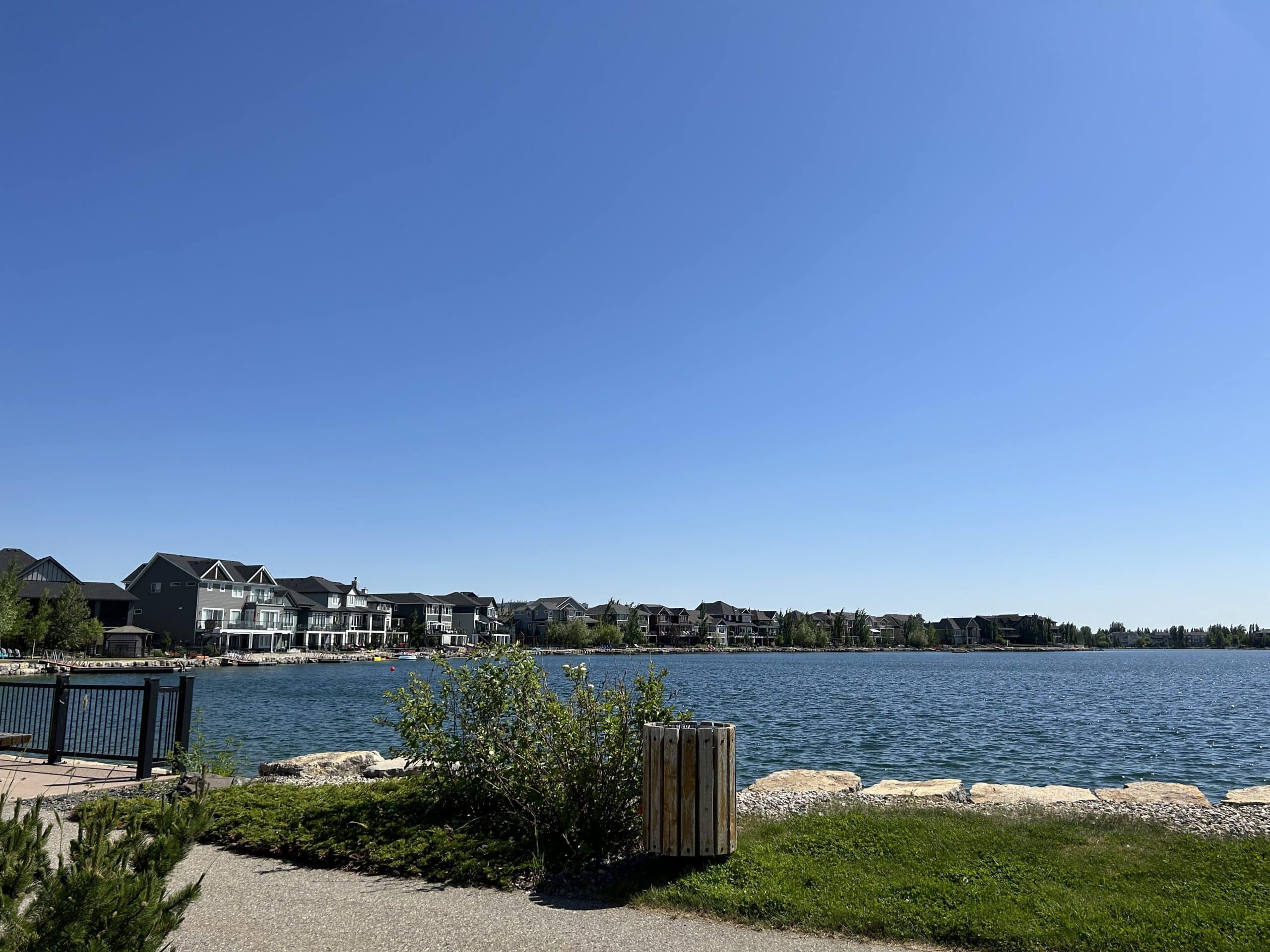 Lakefront homes in Auburn Bay Calgary with scenic walking paths, calm water views, and a vibrant four season lake community atmosphere