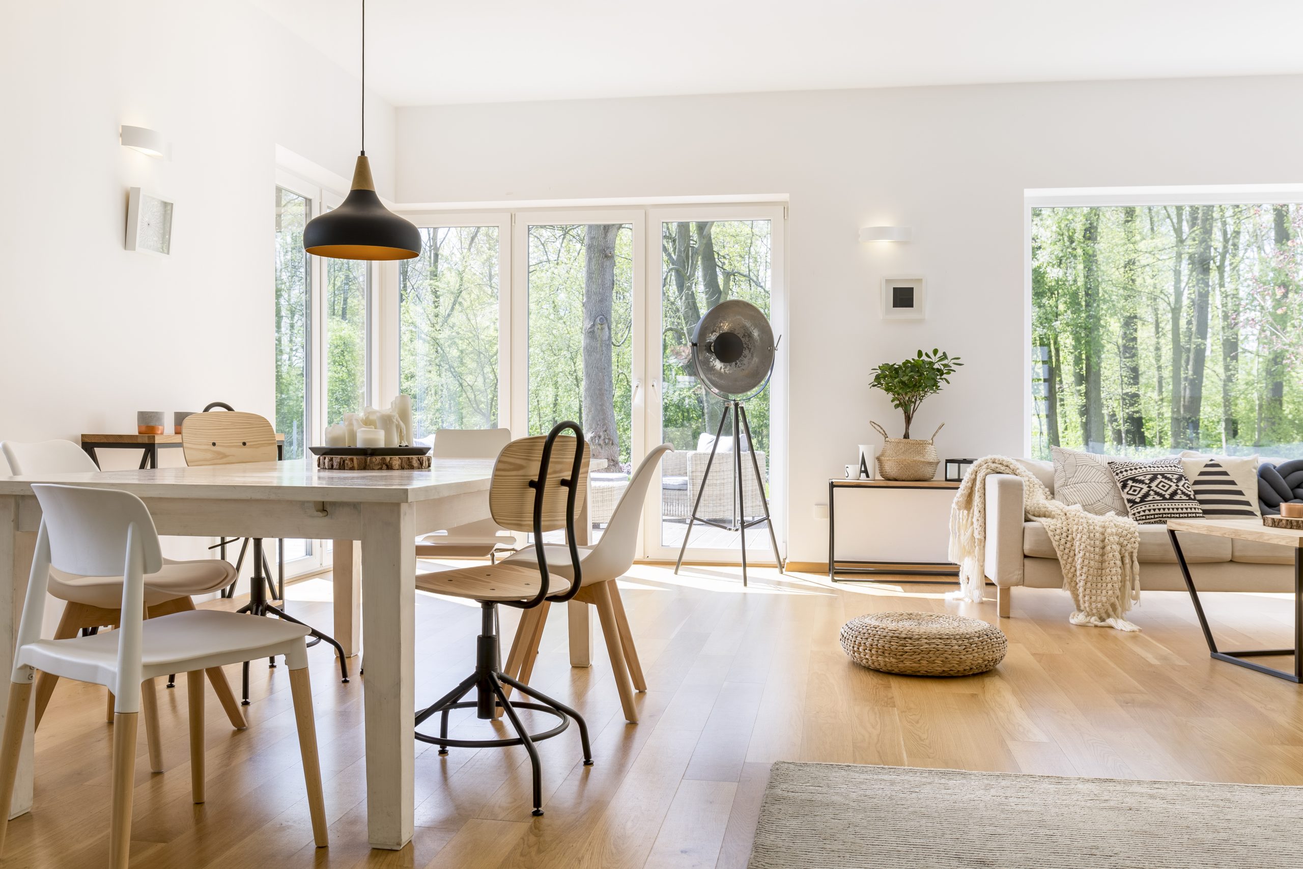 Bright open concept living and dining area with large windows, natural light, and modern finishes in Calgary home