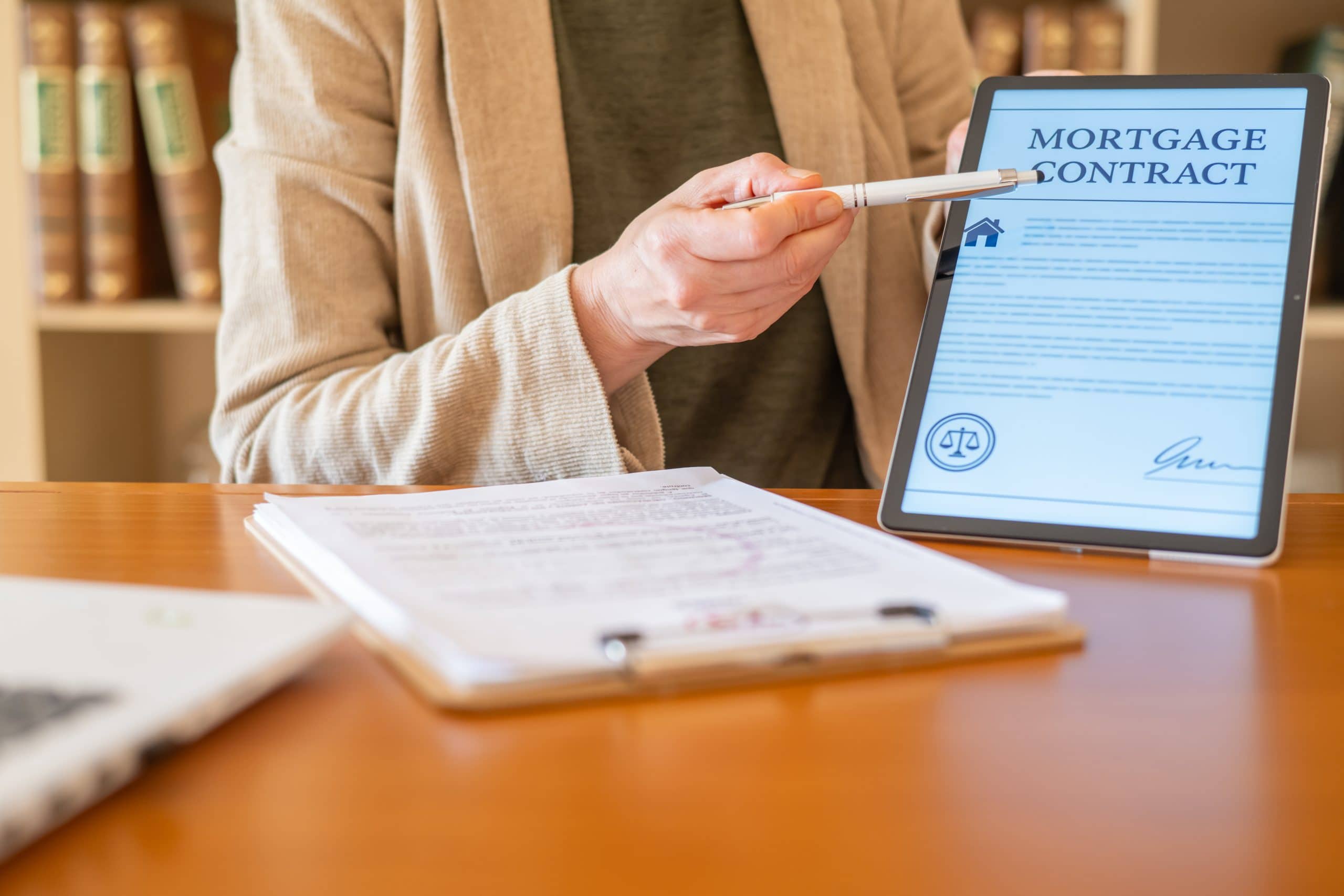 Person reviewing a mortgage contract on a tablet, illustrating the complete mortgage guide for buying a home in Calgary including approval and financing steps