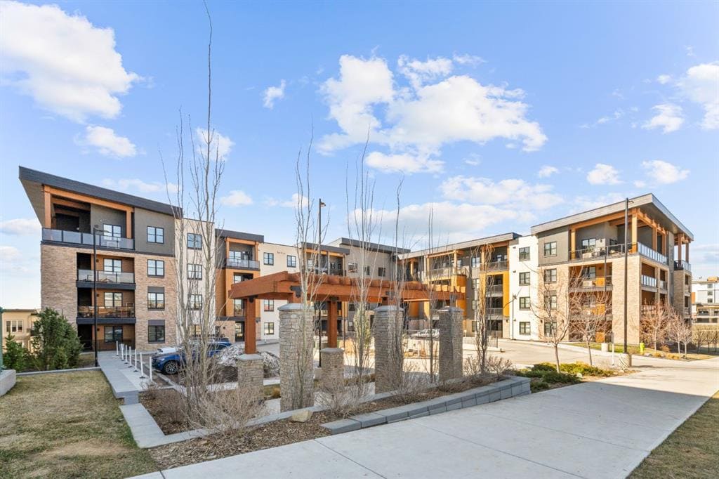 Modern exterior of 85th and Park at 8355 19 Avenue SW in Springbank Hill Calgary, showcasing contemporary architecture, landscaped courtyard, and upscale west side condo living