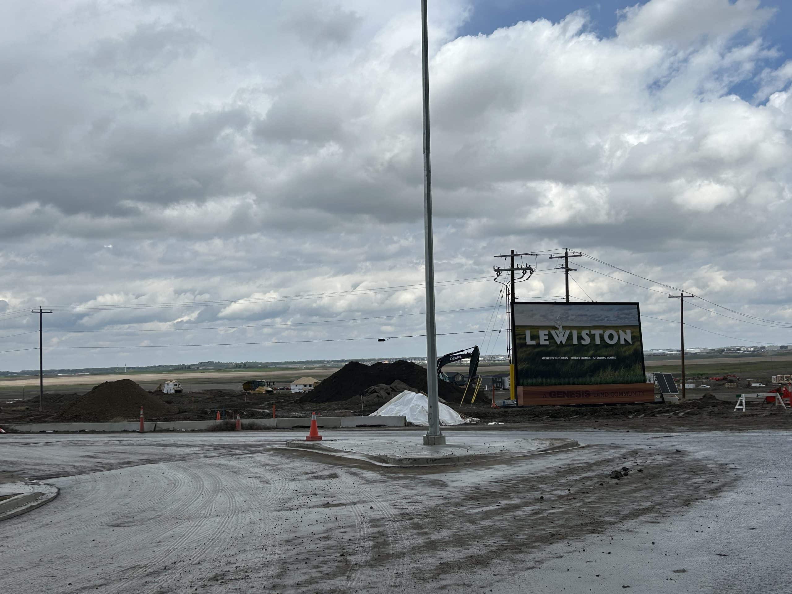 Early stage Calgary community development in Lewiston with active construction and limited infrastructure highlighting the realities of new neighbourhood growth