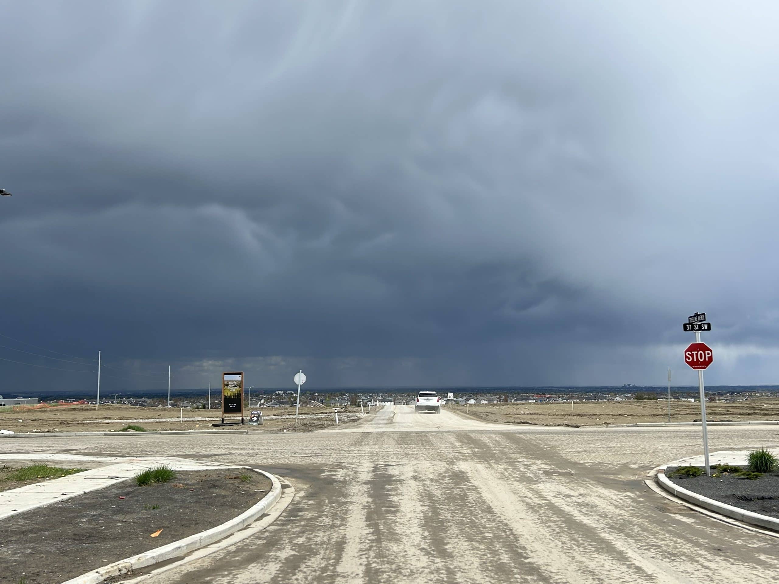 Early stage development in Alpine Park Calgary with unpaved roads and minimal infrastructure showing the realities of living in a new community
