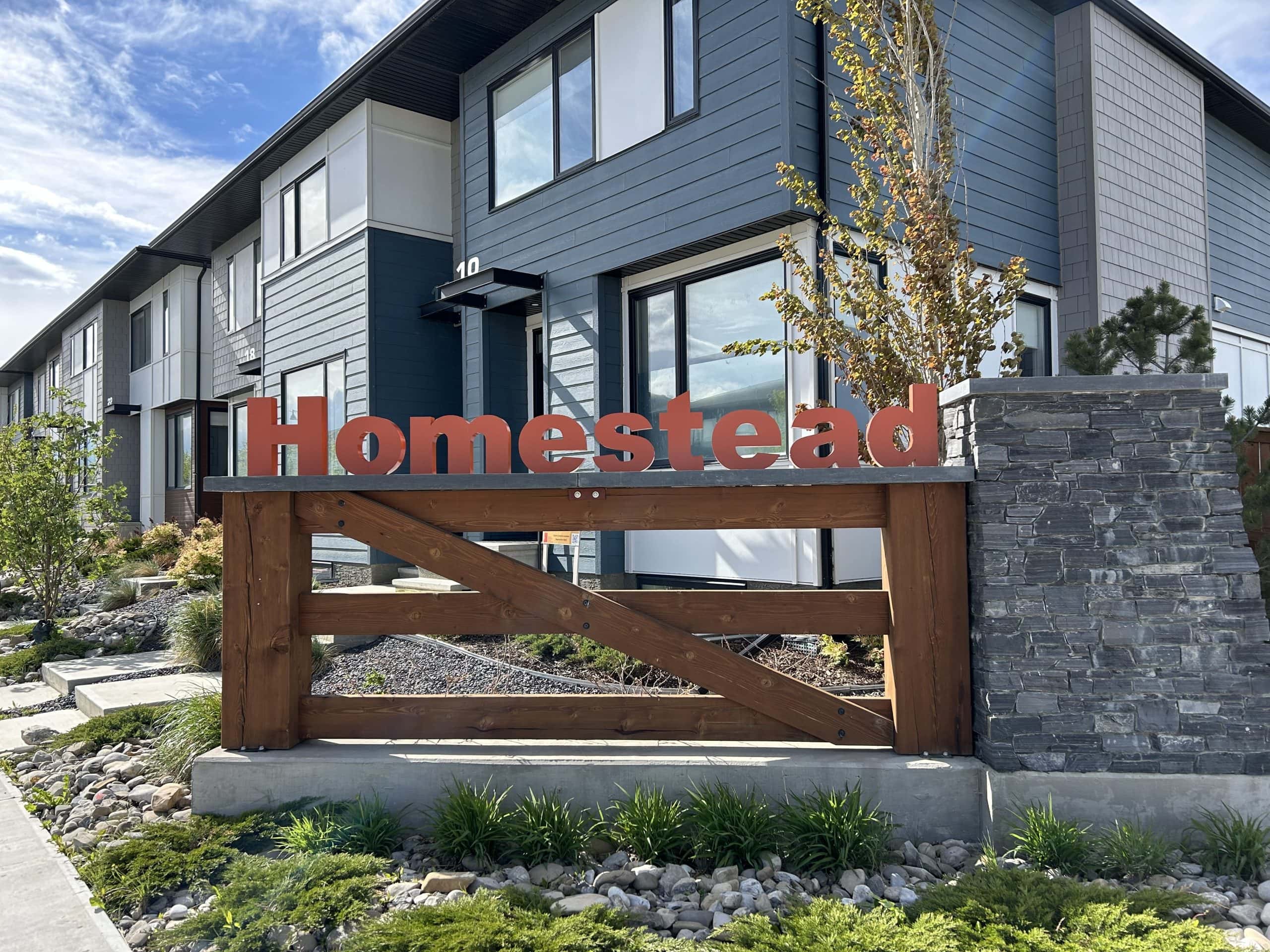 New Calgary community in Homestead with modern townhomes and early landscaping highlighting suburban development and growing neighbourhoods
