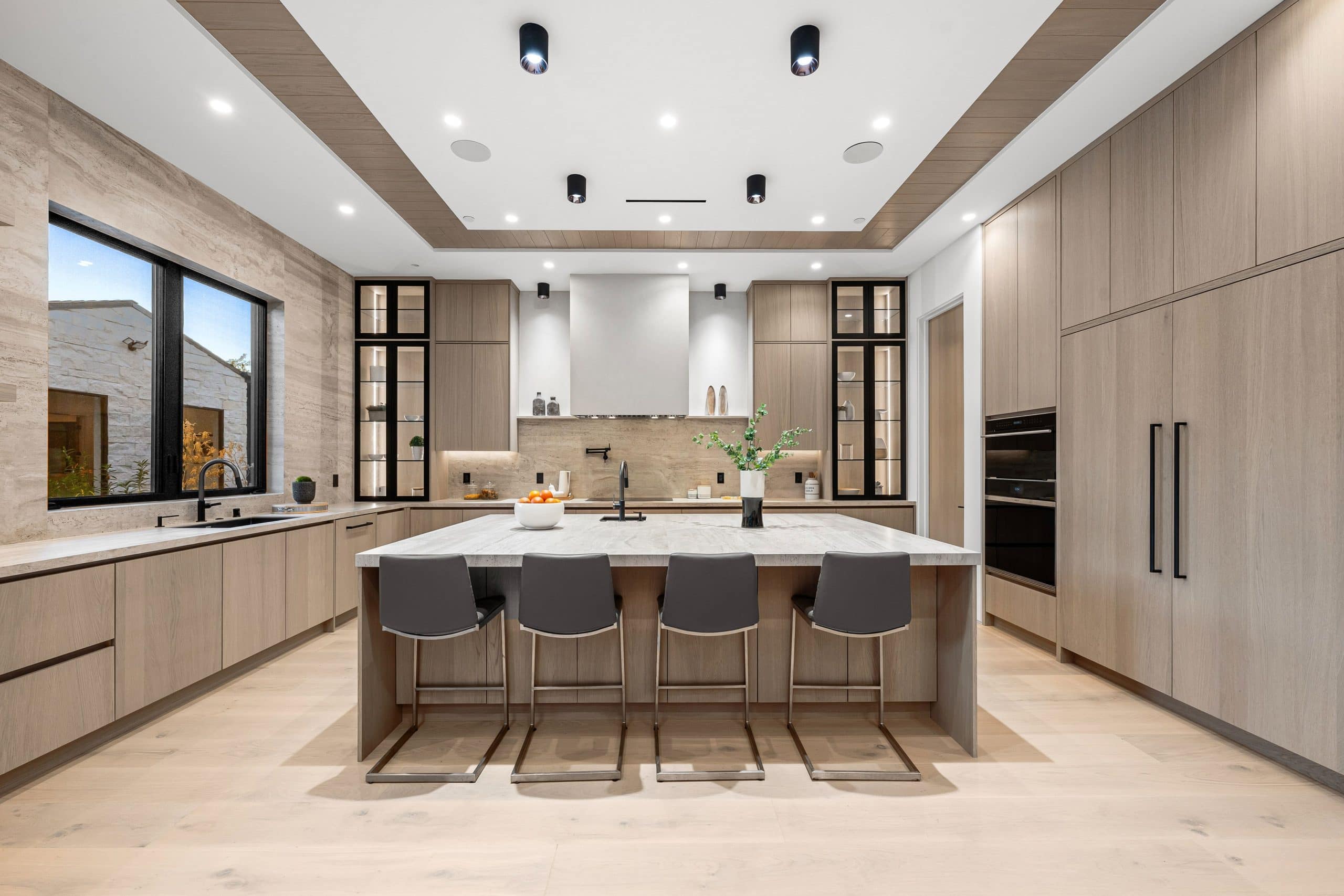 Modern new construction kitchen in Calgary with high end finishes and upgraded cabinetry illustrating the appeal and cost of builder upgrades