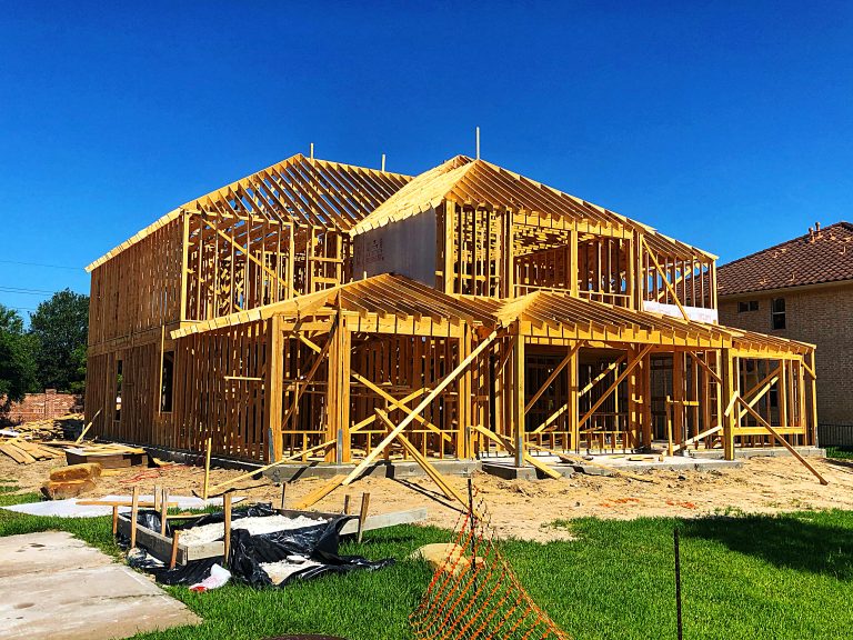 New construction home framing in Calgary showing early build stage, highlighting the realities and considerations of buying a brand new home