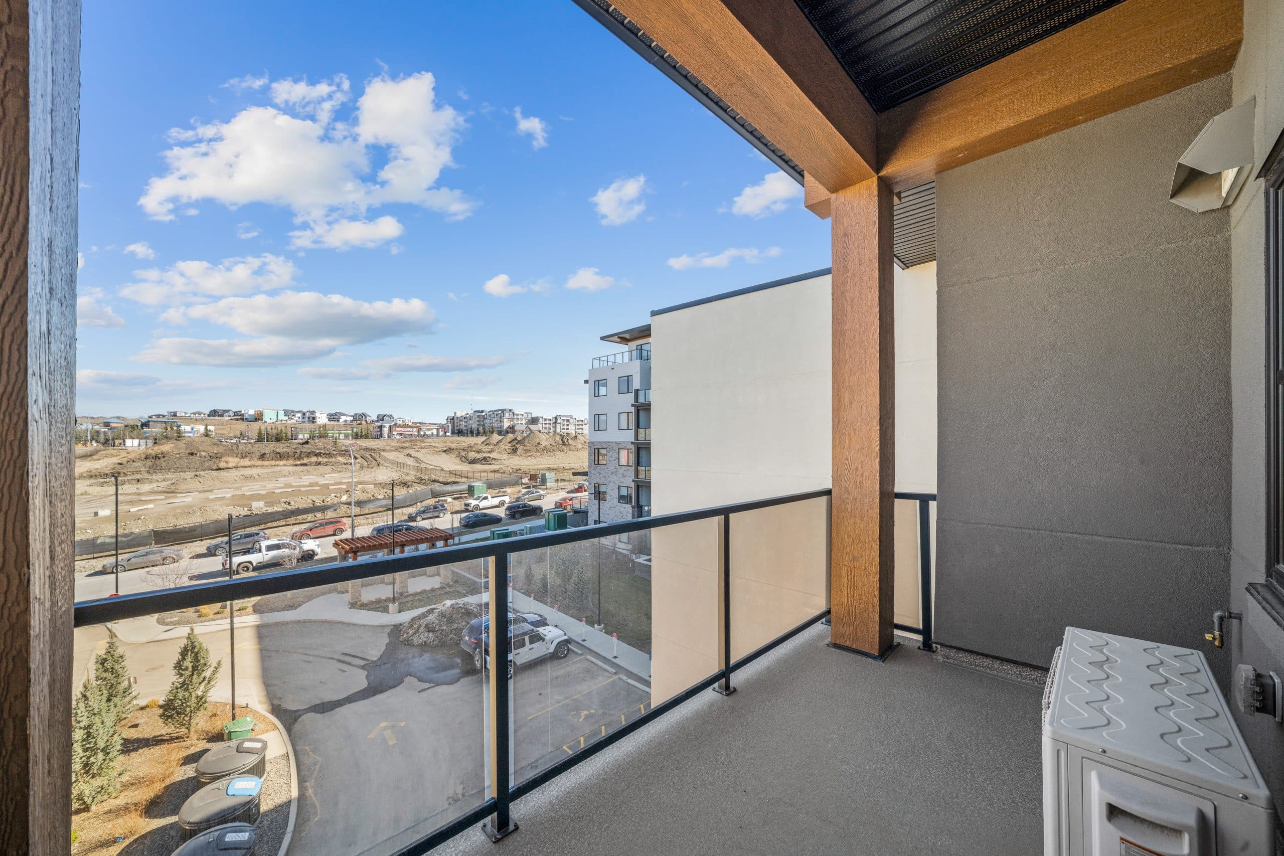 View from a modern Calgary condo balcony overlooking new residential construction and growing housing supply in the local real estate market.