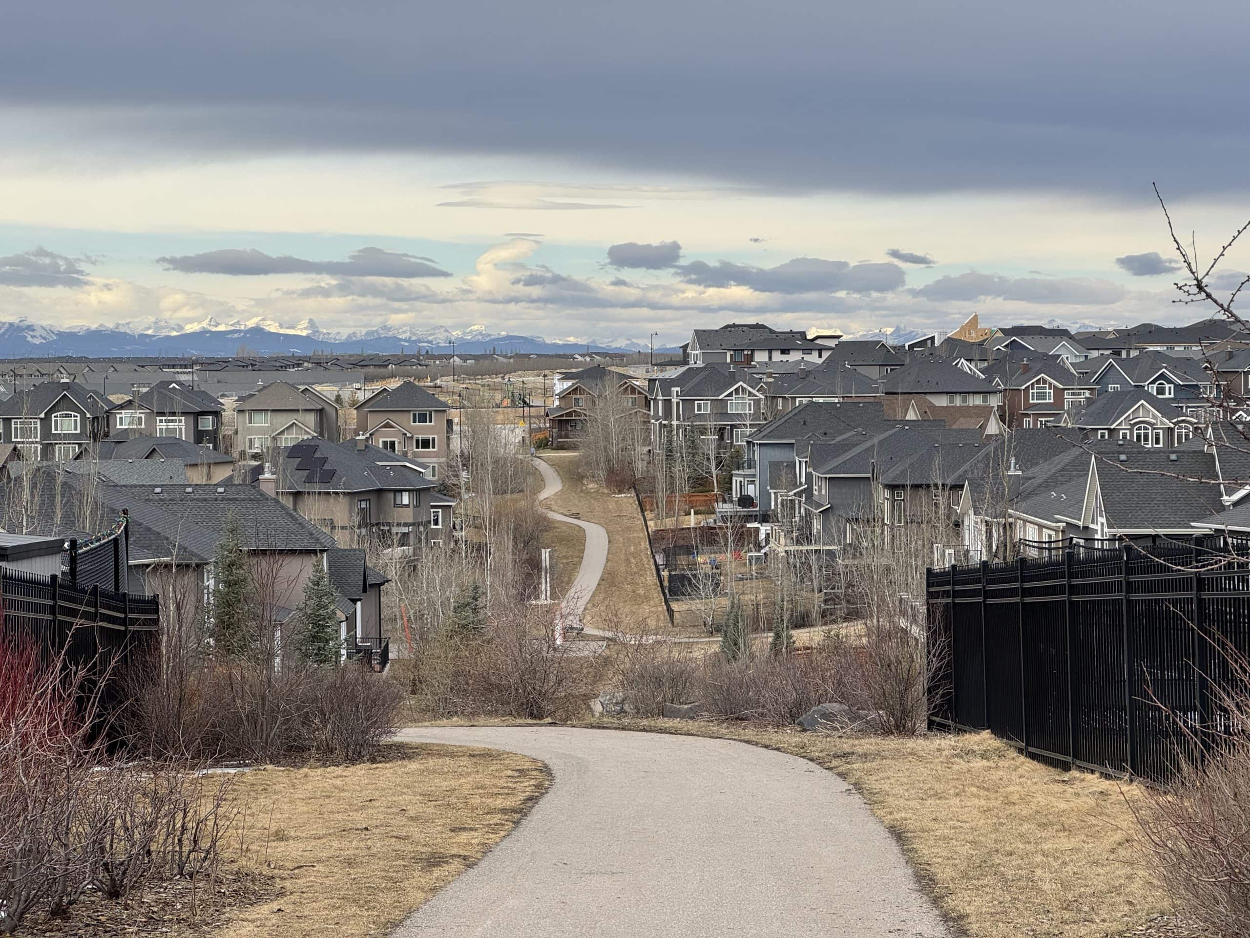 Luxury homes in Aspen Woods Calgary with elevated mountain views, large modern properties, and scenic pathways throughout the Aspen Estates area.