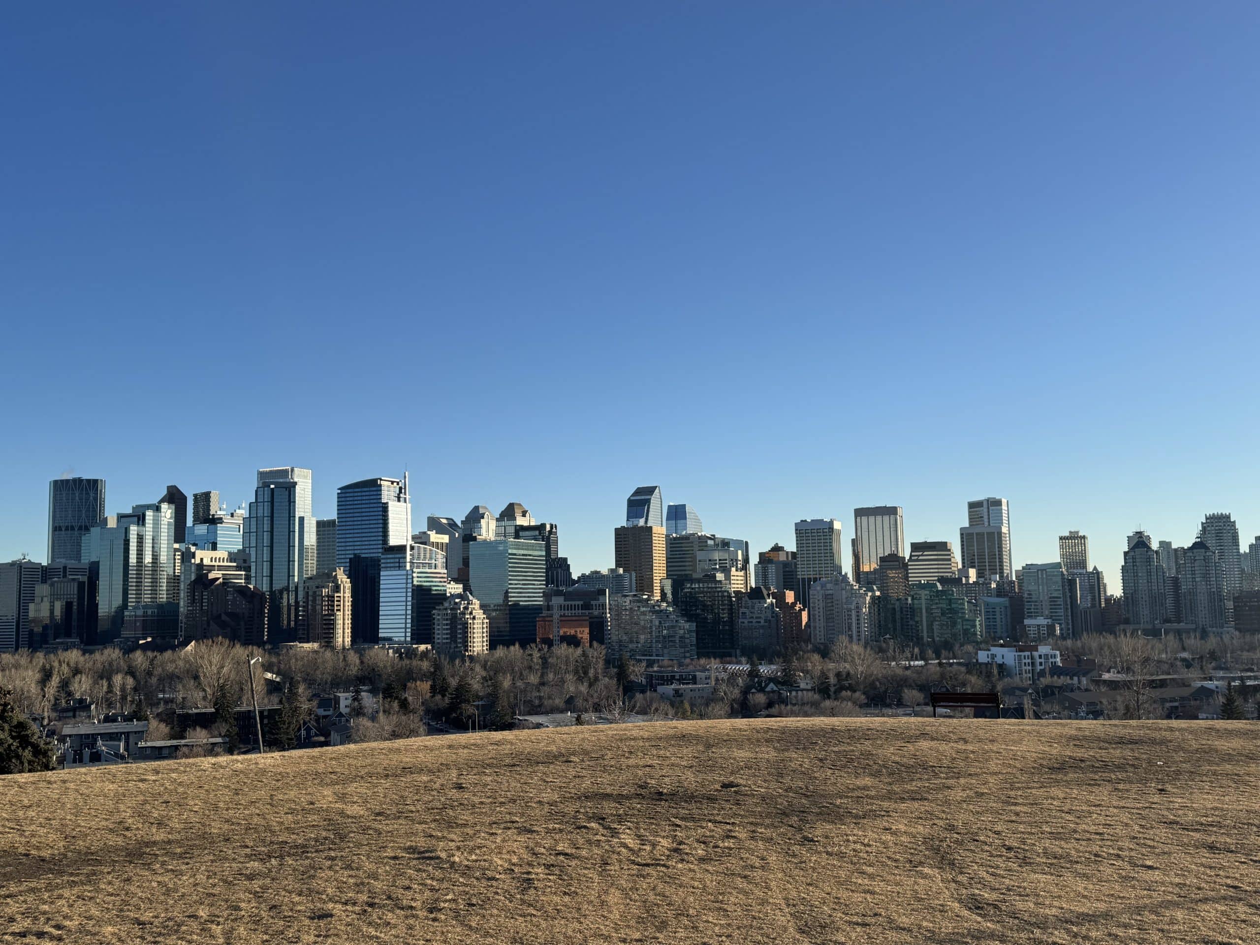 Panoramic downtown Calgary skyline views from one of the city’s elevated ridge areas, where premium locations help drive luxury home values.