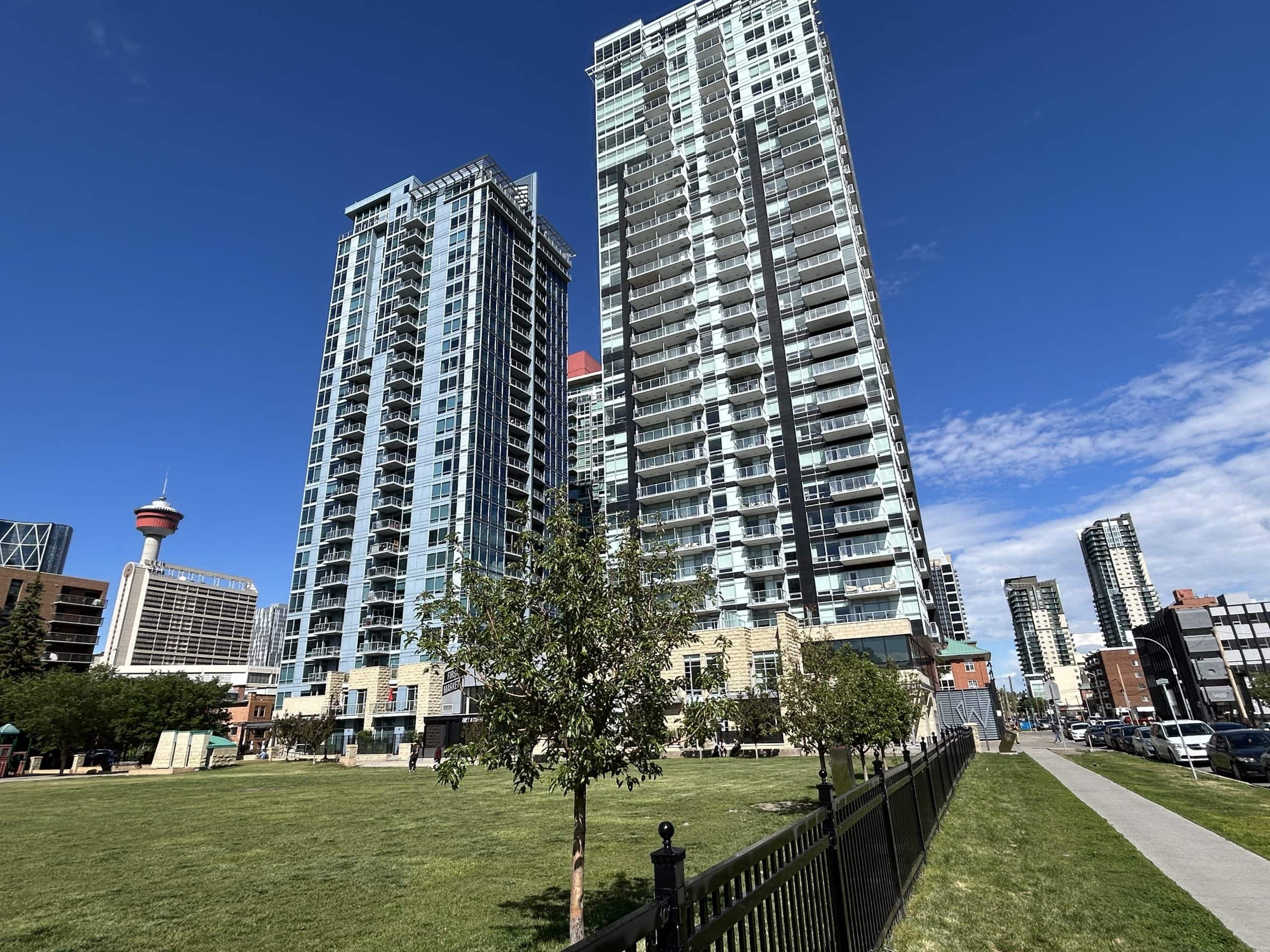 Modern Calgary condo towers in the Beltline highlighting condo ownership, rising condo fees, and the realities of buying a condo in Calgary.