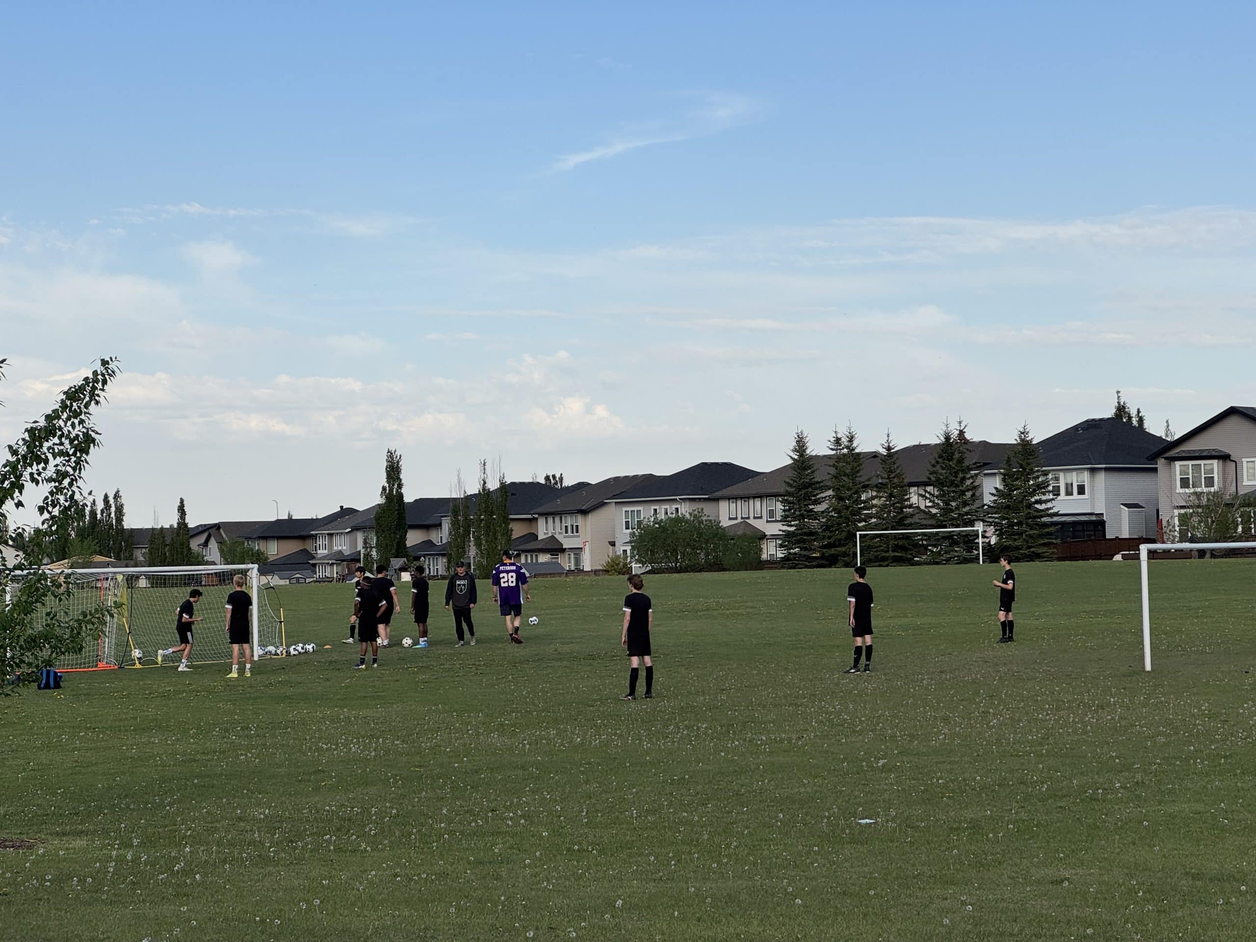 Youth soccer practice on a community sports field in McKenzie Towne Calgary, showcasing the neighbourhood's family friendly atmosphere, recreational amenities, green spaces, and active outdoor lifestyle.