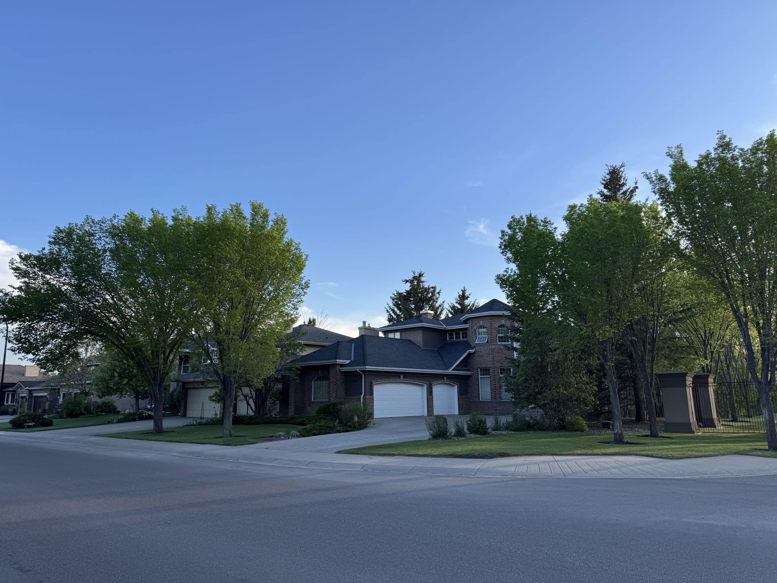 Luxury estate home in McKenzie Lake surrounded by mature trees and oversized lots, showcasing the established character, executive properties, and upscale streetscapes that make this one of southeast Calgary's most sought after lake communities.
