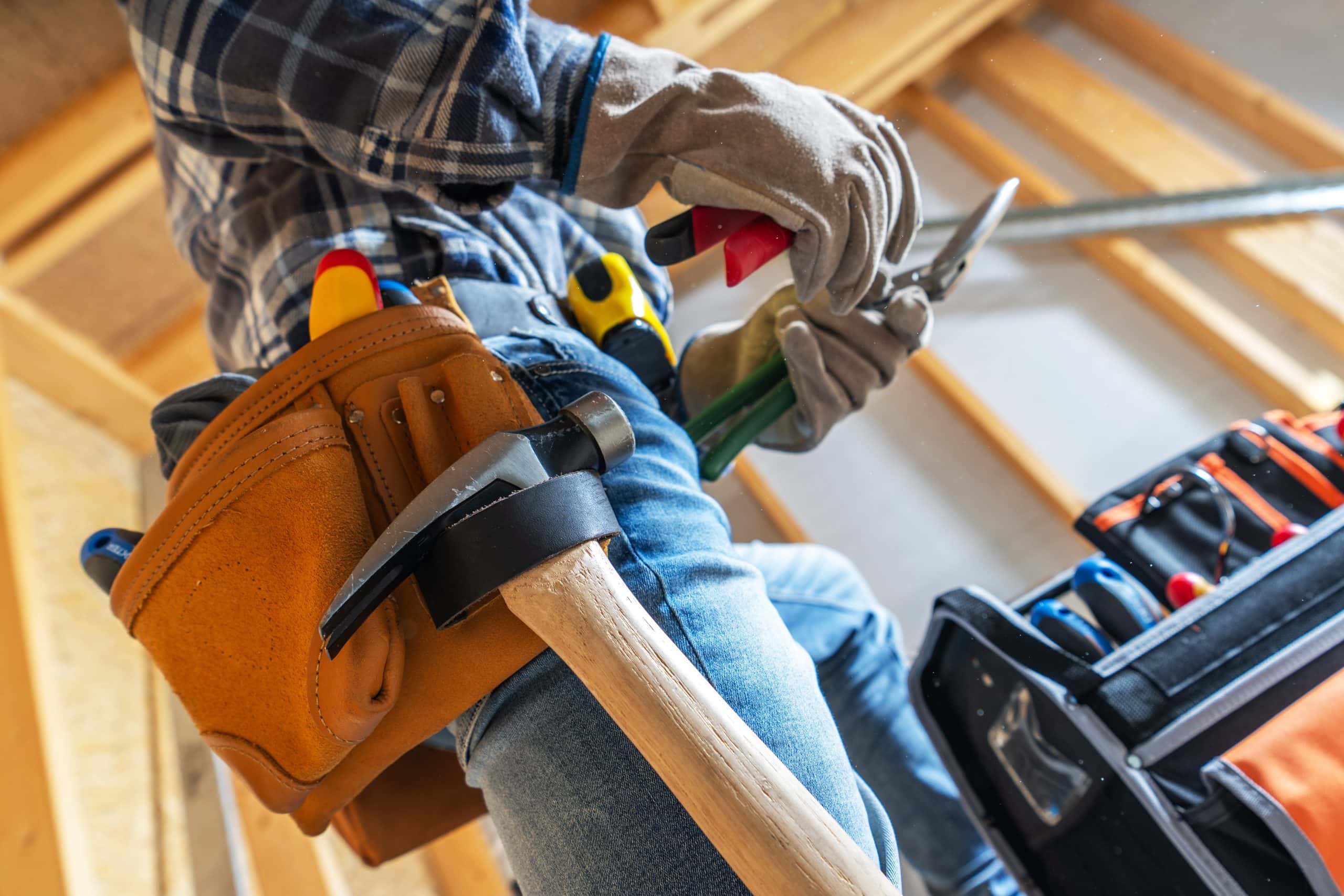 Contractor repairing a home in Calgary, representing unexpected maintenance costs, repairs, and ongoing home ownership expenses after buying a property.