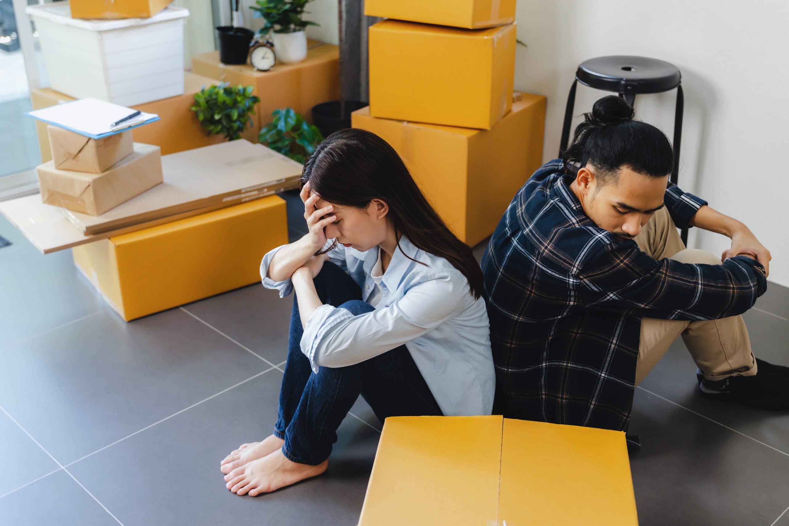 Calgary home buyer experiencing stress and regret after purchasing a house, representing common mistakes, financial pressure, and home buyer remorse in Calgary real estate.
