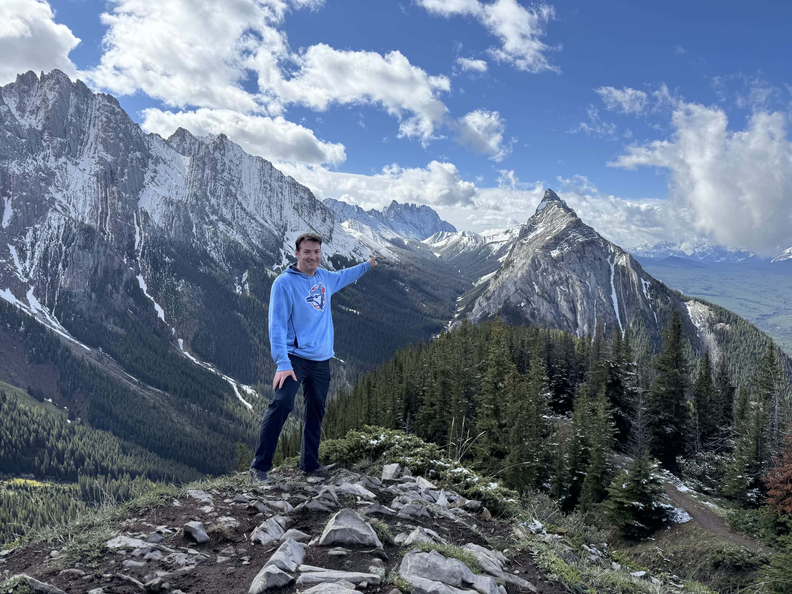 Ryan enjoying panoramic views from the King Creek Ridge viewpoint overlooking Mount Lougheed and Kananaskis Country.