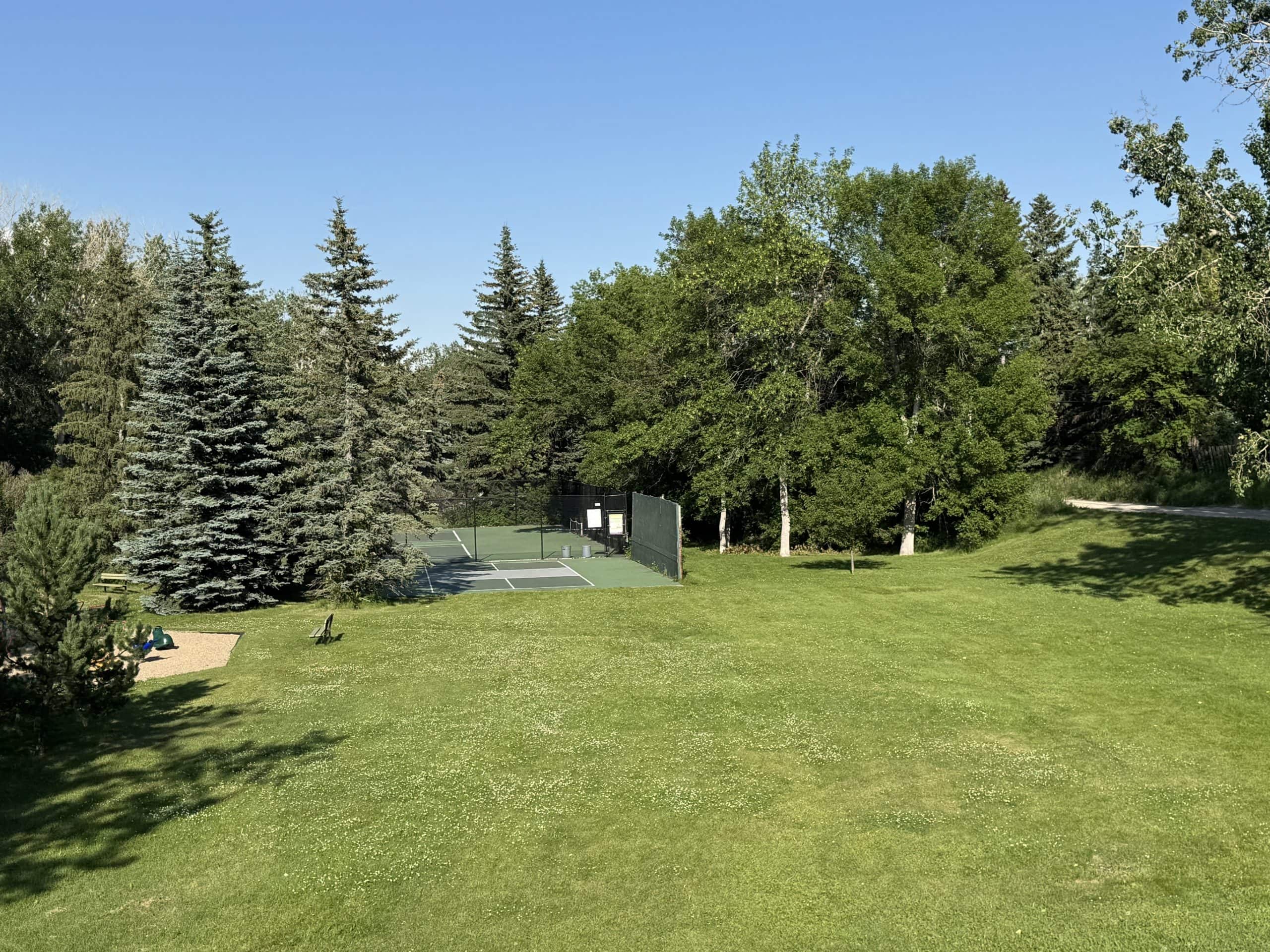 Tennis courts and mature green space in Glendale, Calgary, highlighting the neighbourhood's parks and recreational amenities.