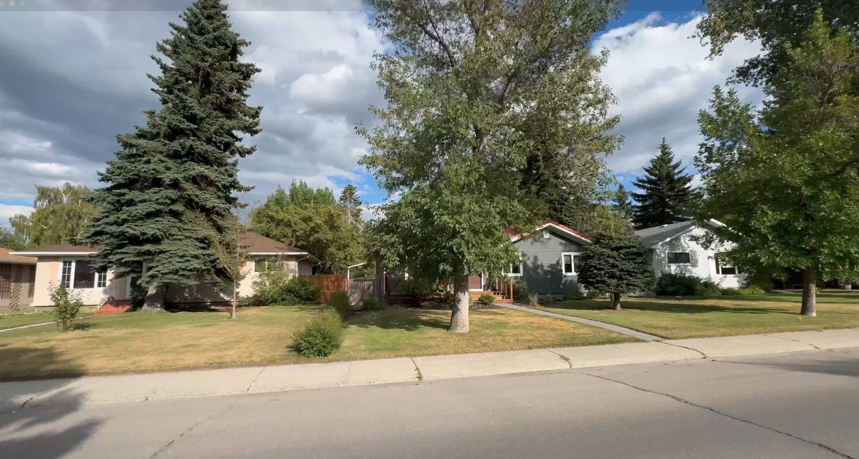Mature tree lined street with classic bungalow homes in Glamorgan, one of Calgary's established southwest neighbourhoods.