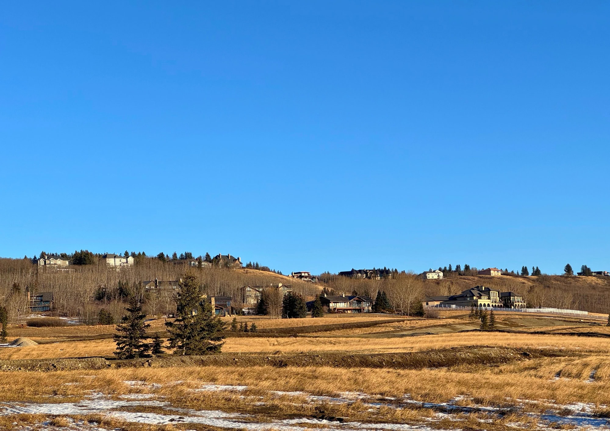 Luxury estate homes in Springbank, an exclusive rural community west of Calgary known for expansive acreages, rolling hills, mountain views, and private country living.