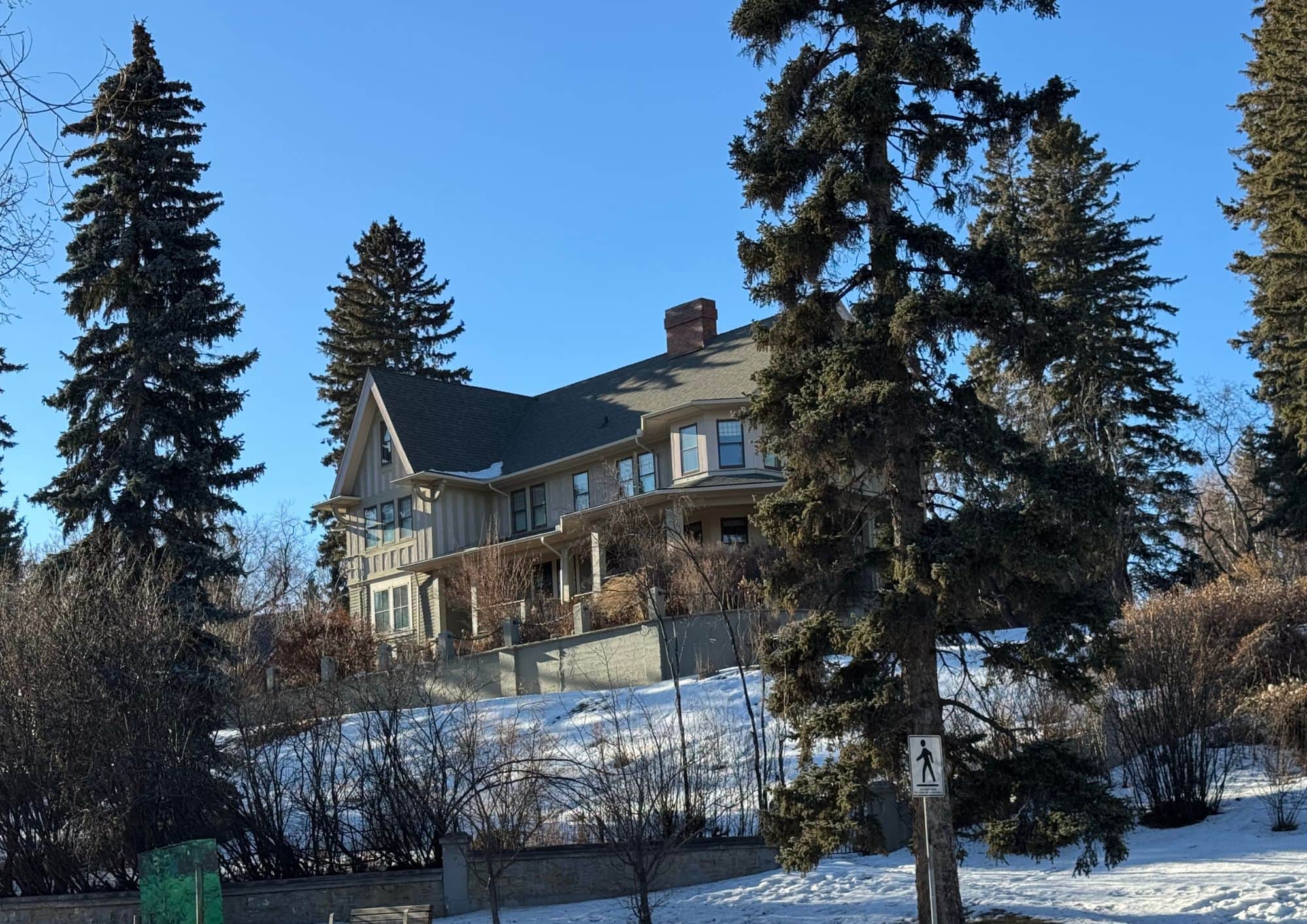 Luxury estate home in Upper Mount Royal, one of Calgary's most prestigious neighbourhoods, surrounded by mature trees and large estate lots.