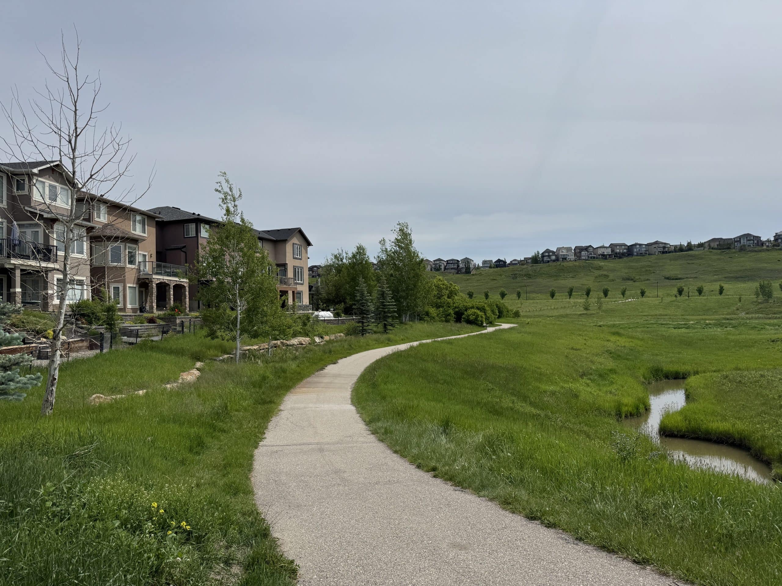 Sage Hill homes backing onto scenic green space and walking paths in northwest Calgary, Alberta.