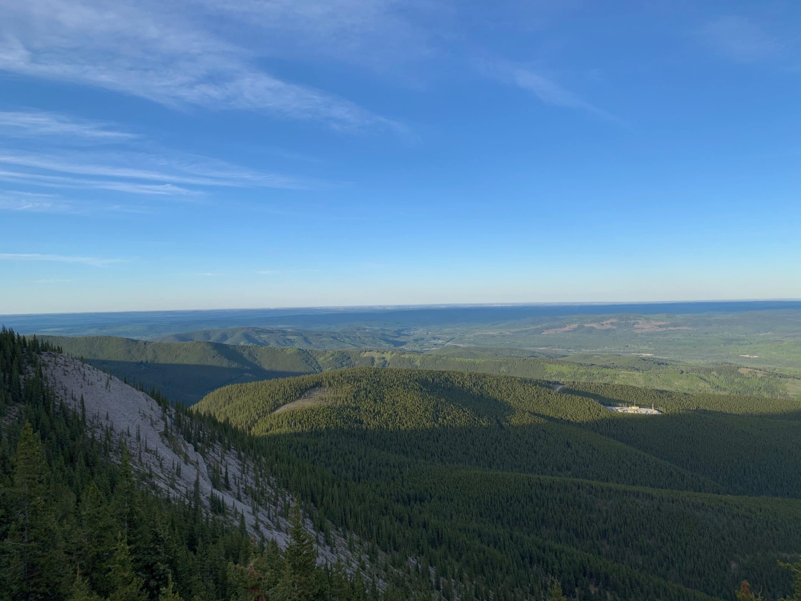 View from Prairie Mountain near Bragg Creek, Alberta, looking across the forested foothills toward Calgary.