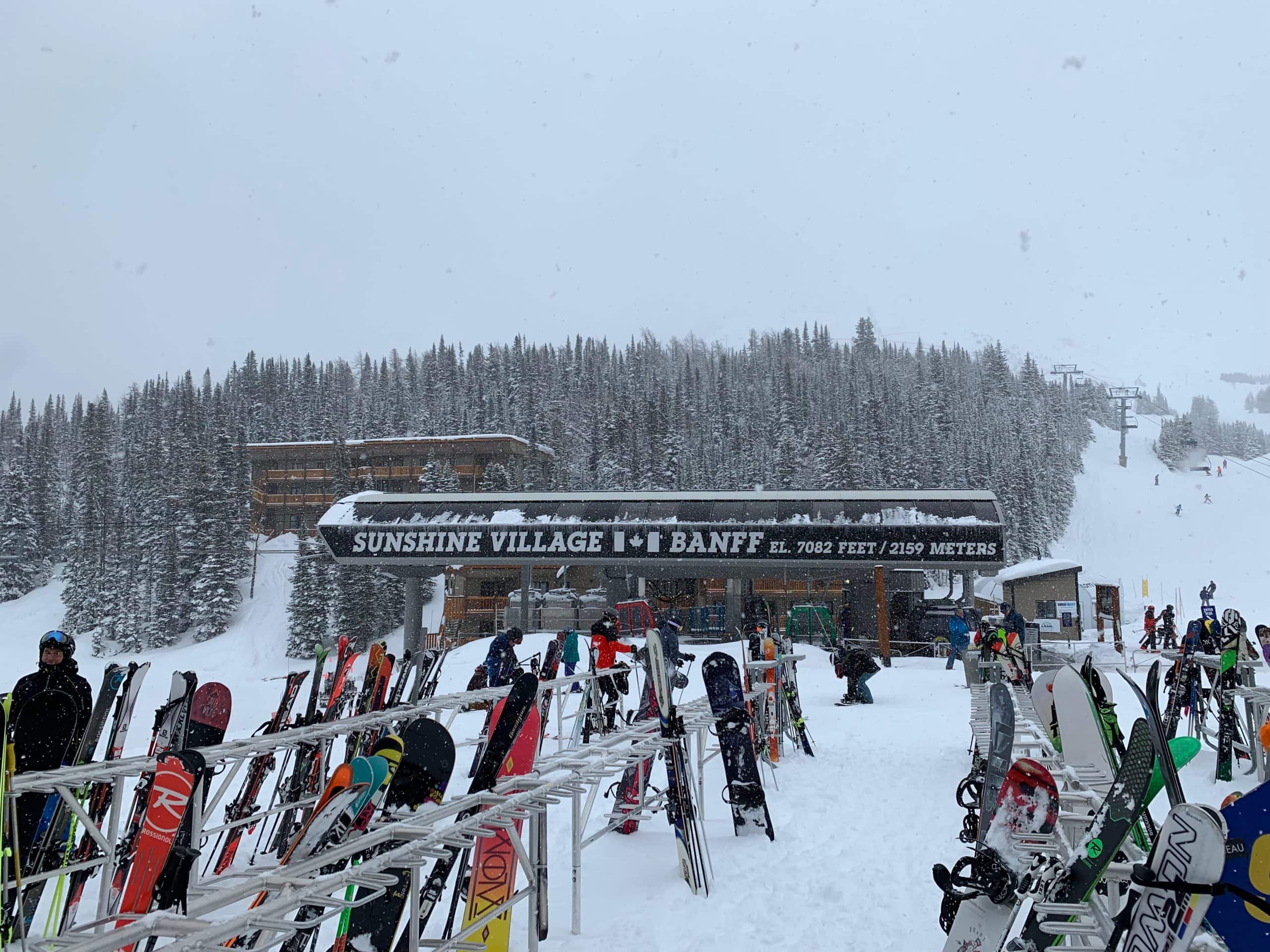 Skiers and snowboarders at Sunshine Village in Banff National Park during a snowy winter day in the Canadian Rockies.