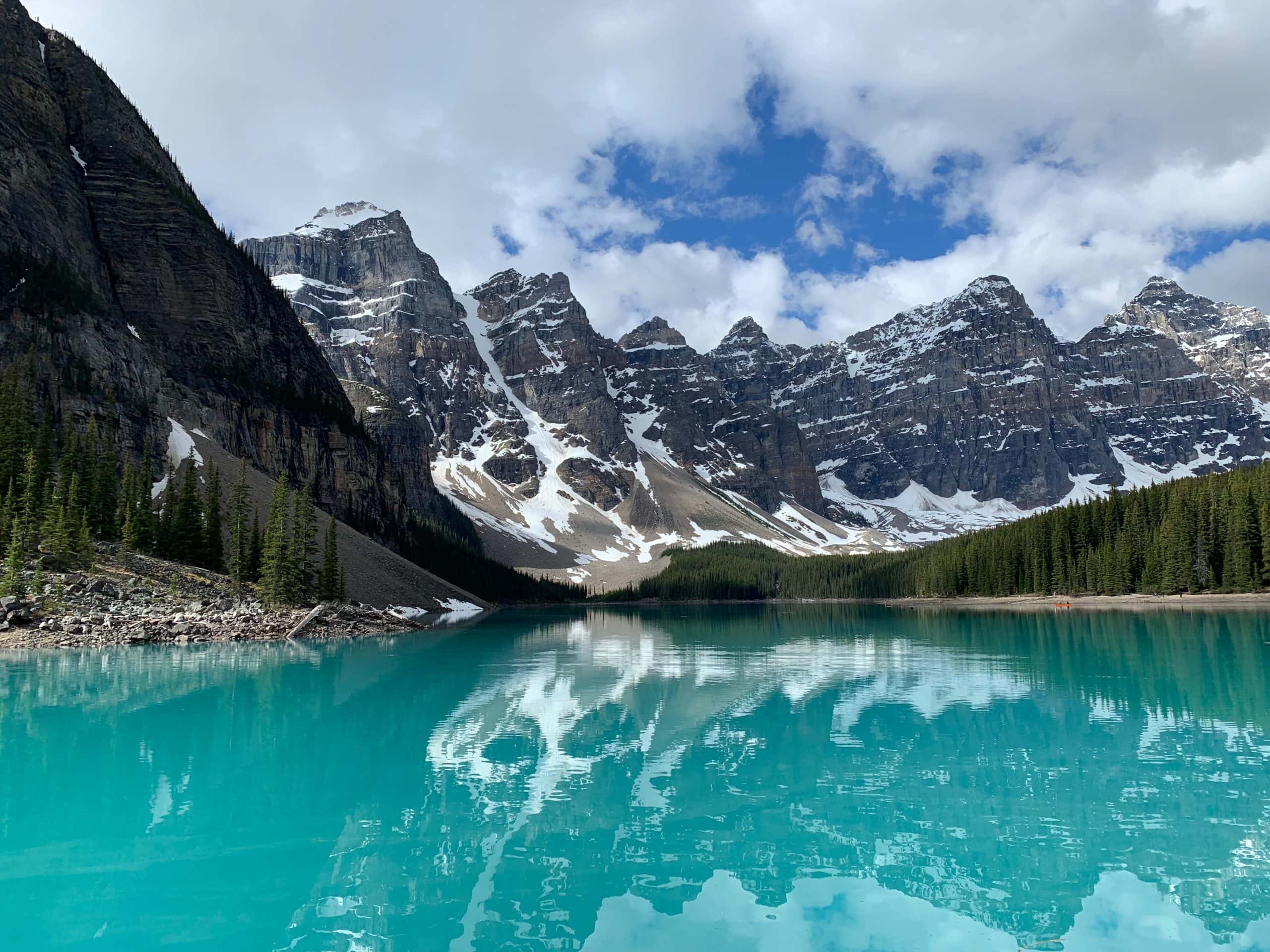 Moraine Lake in Banff National Park, with turquoise water reflecting the snow capped peaks of the Valley of the Ten Peaks.