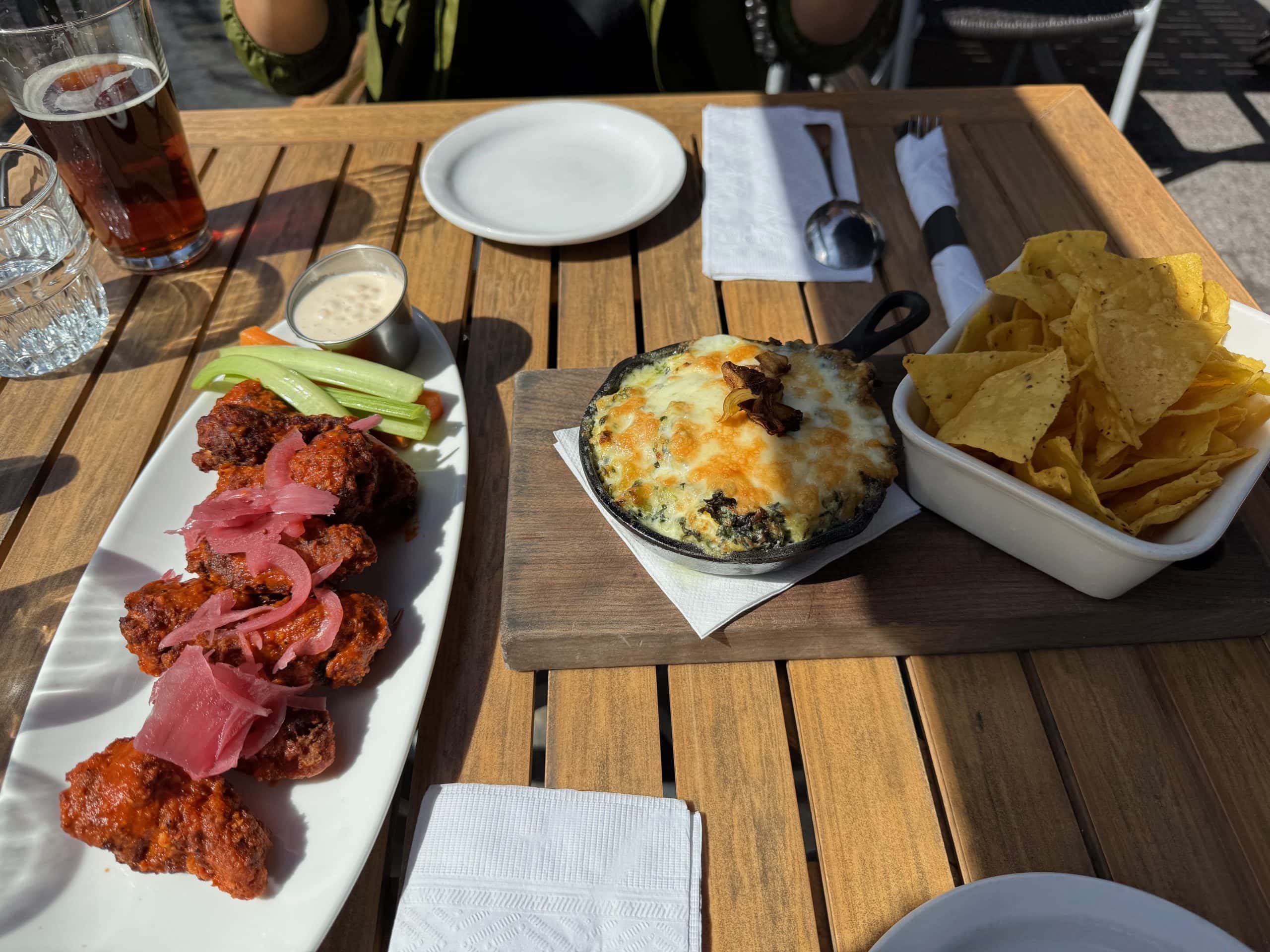 Food and drinks on a sunny patio in Canmore, Alberta, after a day of hiking in the Canadian Rockies.