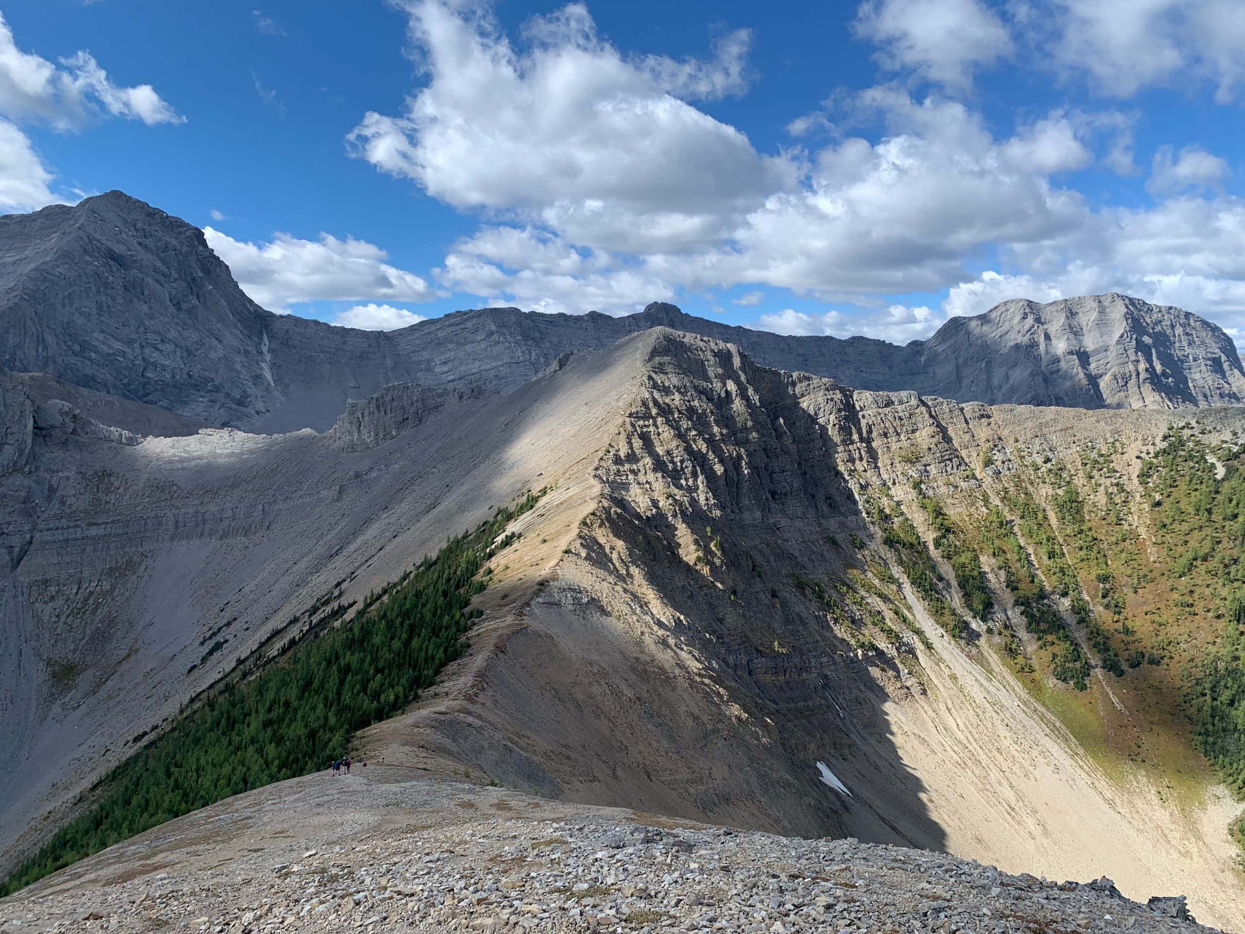 Tent Ridge hike in Kananaskis Country, Alberta, with hikers following a dramatic mountain ridge through the Canadian Rockies.