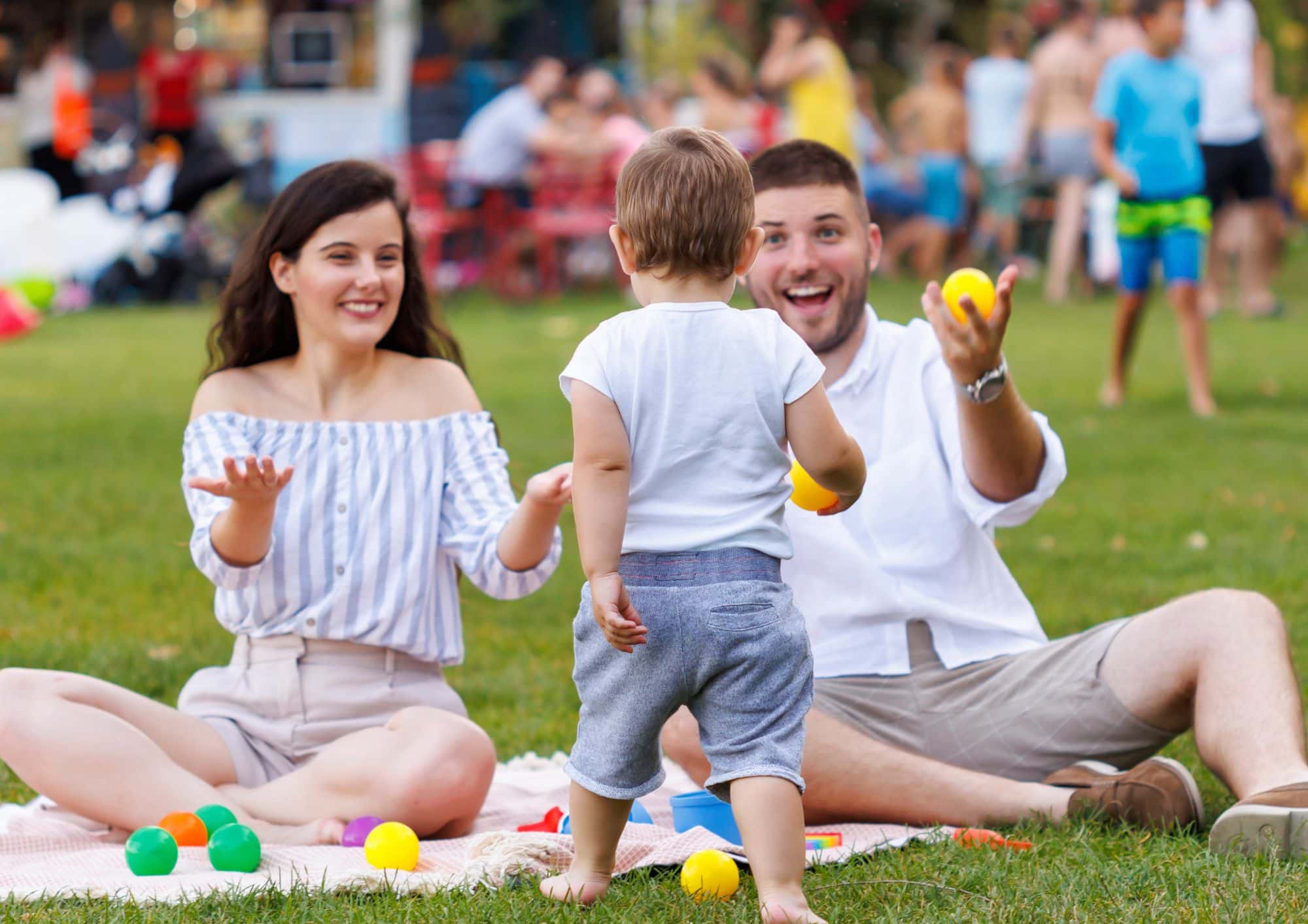 Family enjoying outdoor play together in a Calgary park on a warm summer day.