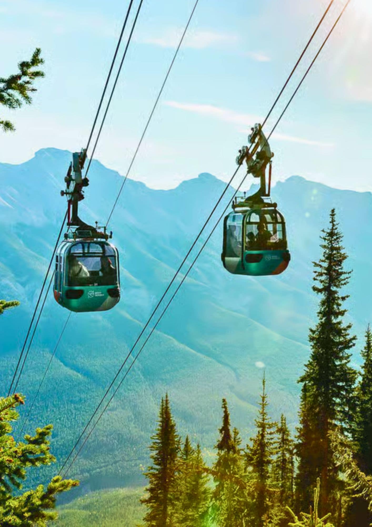 Banff Gondola cabins travelling above the forest with panoramic views of the Canadian Rockies in Banff National Park, Alberta.
