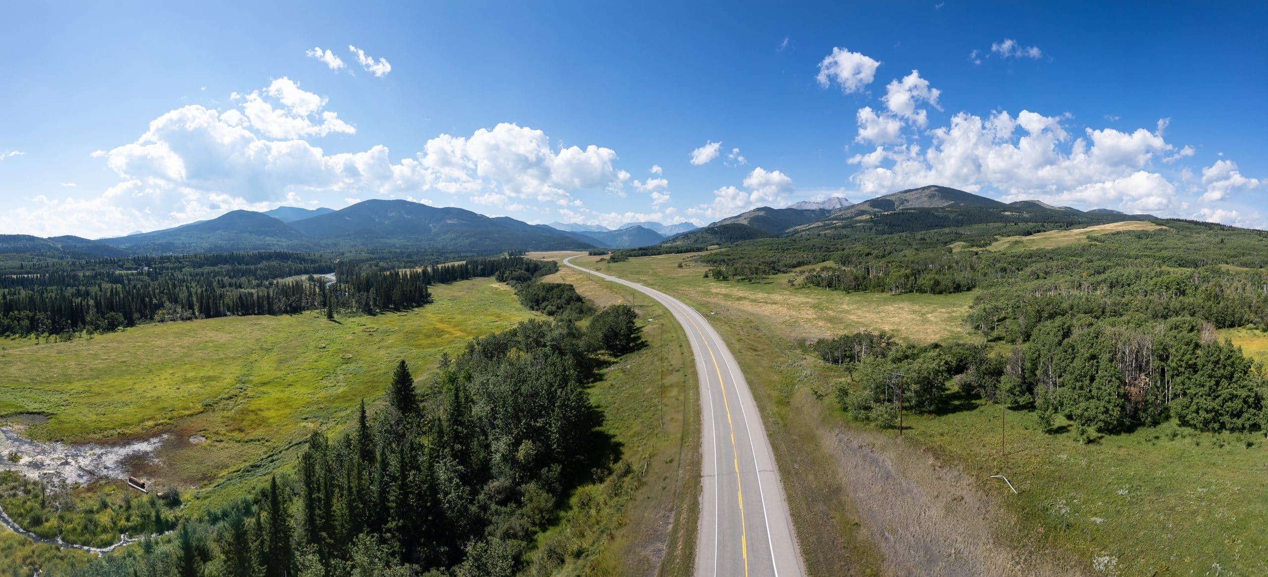 Highway 22 Cowboy Trail through the Alberta foothills with Rocky Mountain views.